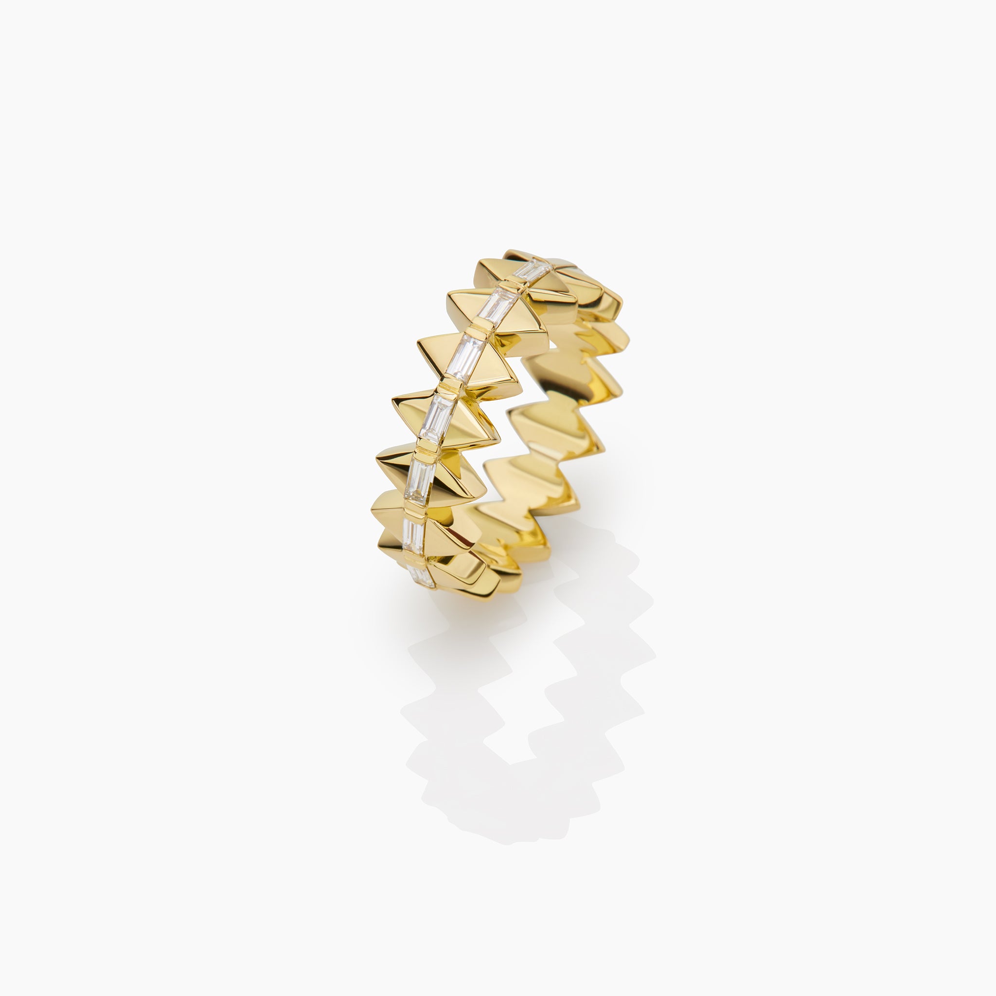 Yellow Gold Solidarity ring with baguette diamonds displayed on off white background