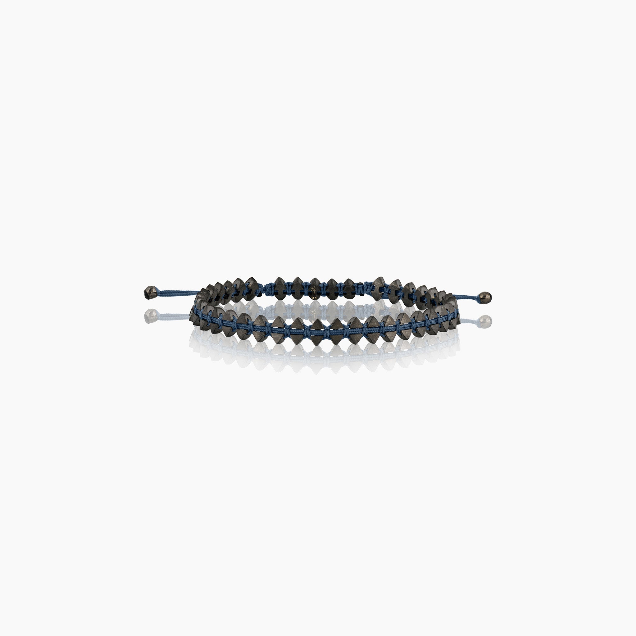 Men's dual-sided anchor bracelet with anchor and boat-inspired triangle motifs, showcased against an off-white background.