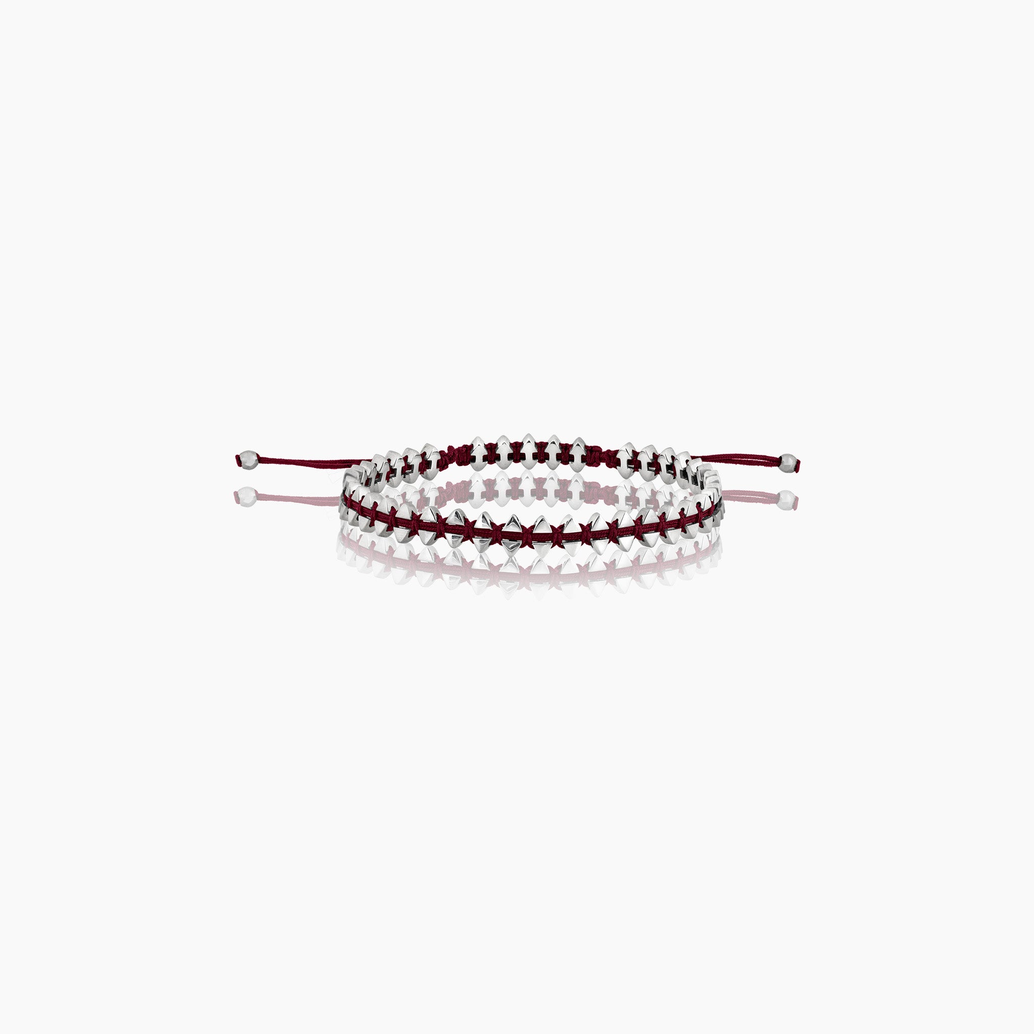 Men's anchor bracelet with dual-sided design, featuring anchor motifs on one side and boat-inspired triangles on the other displayed on off white background.