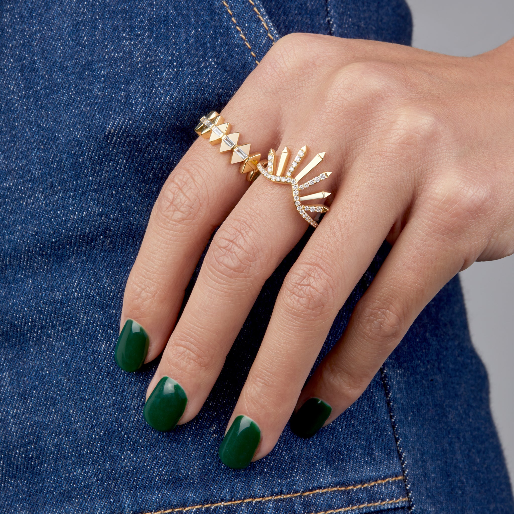 two yellow gold rings displayed on hand model.