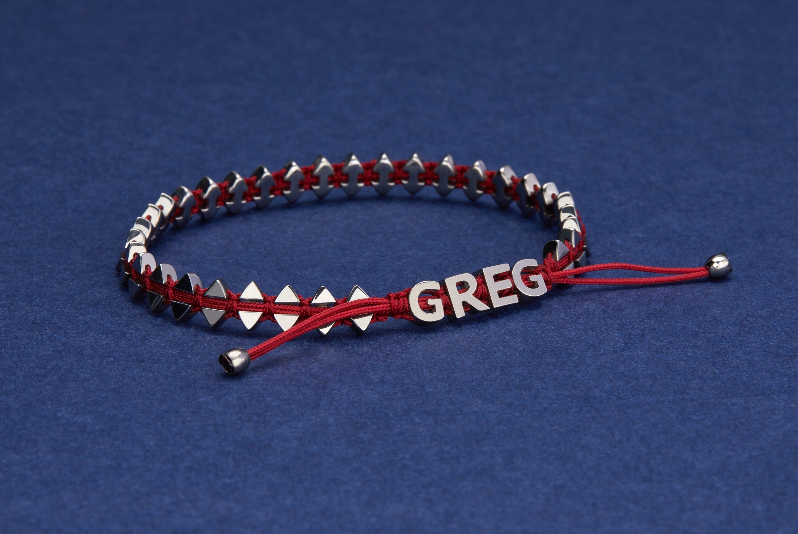 Personalised men's dual-sided anchor bracelet with anchor and boat-inspired triangle motifs, showcased on model.