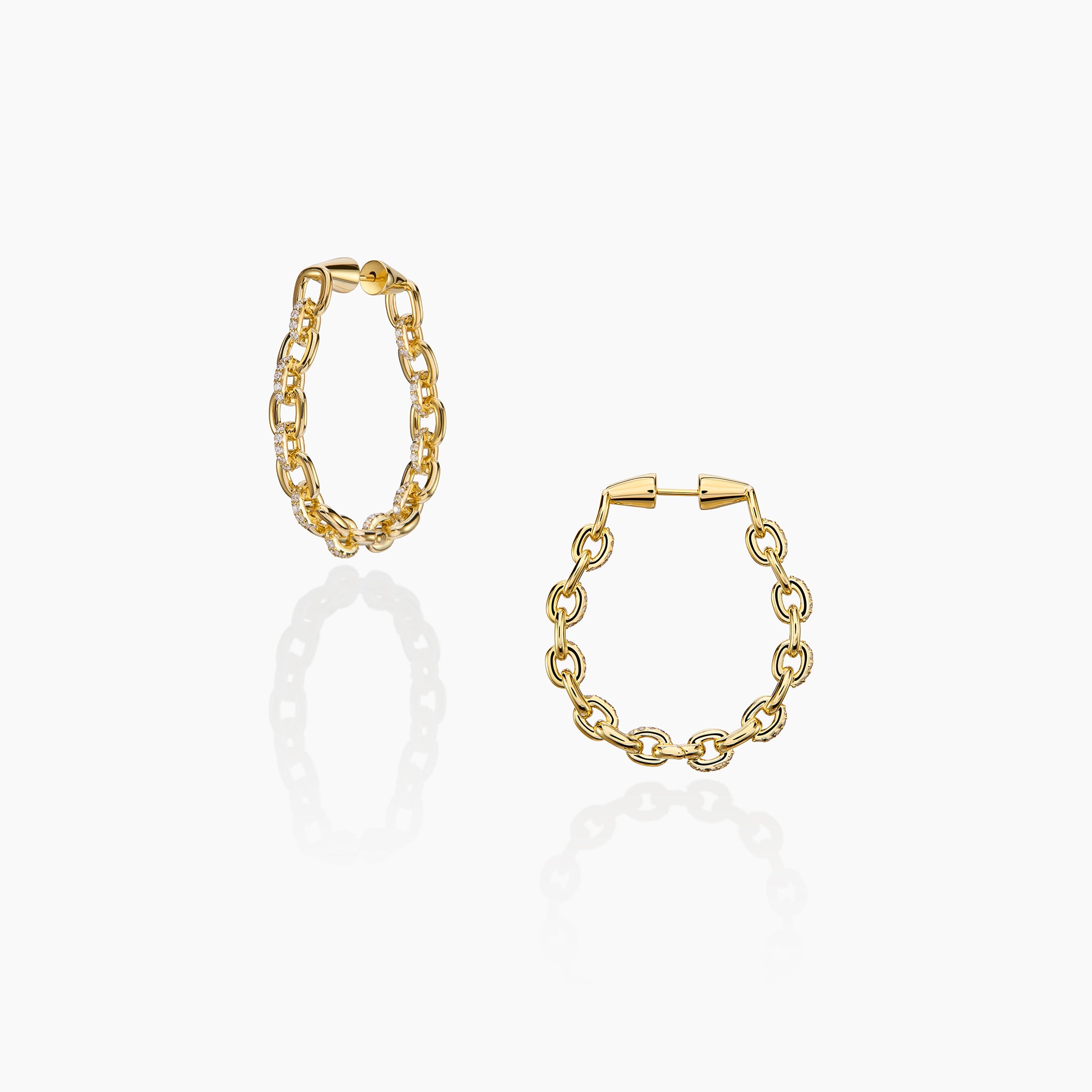 Horsebit Diamond link Hoop Earrings in yellow gold displayed on an off white background.
