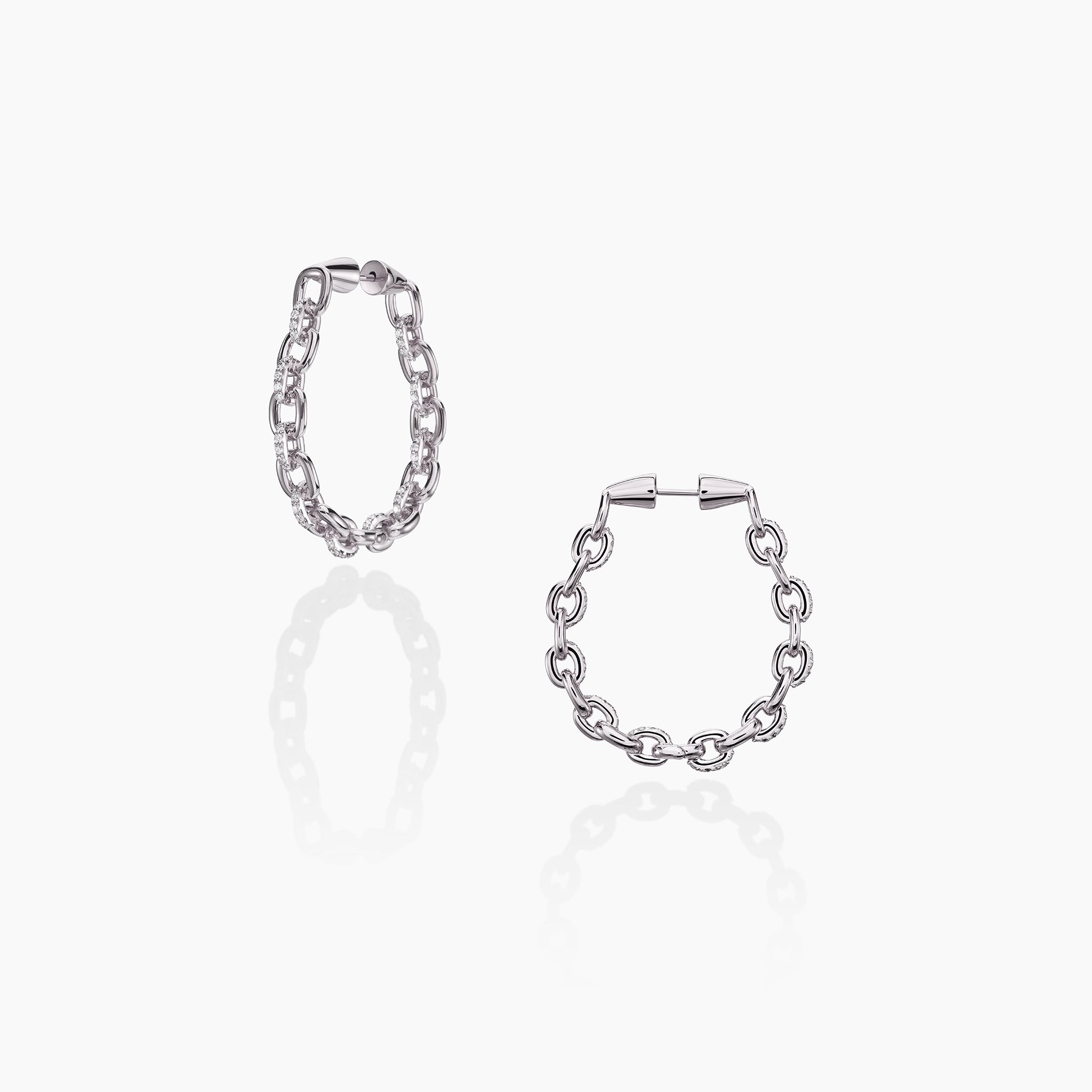 Horsebit Diamond link Hoop Earrings in yellow gold displayed on an off white background.