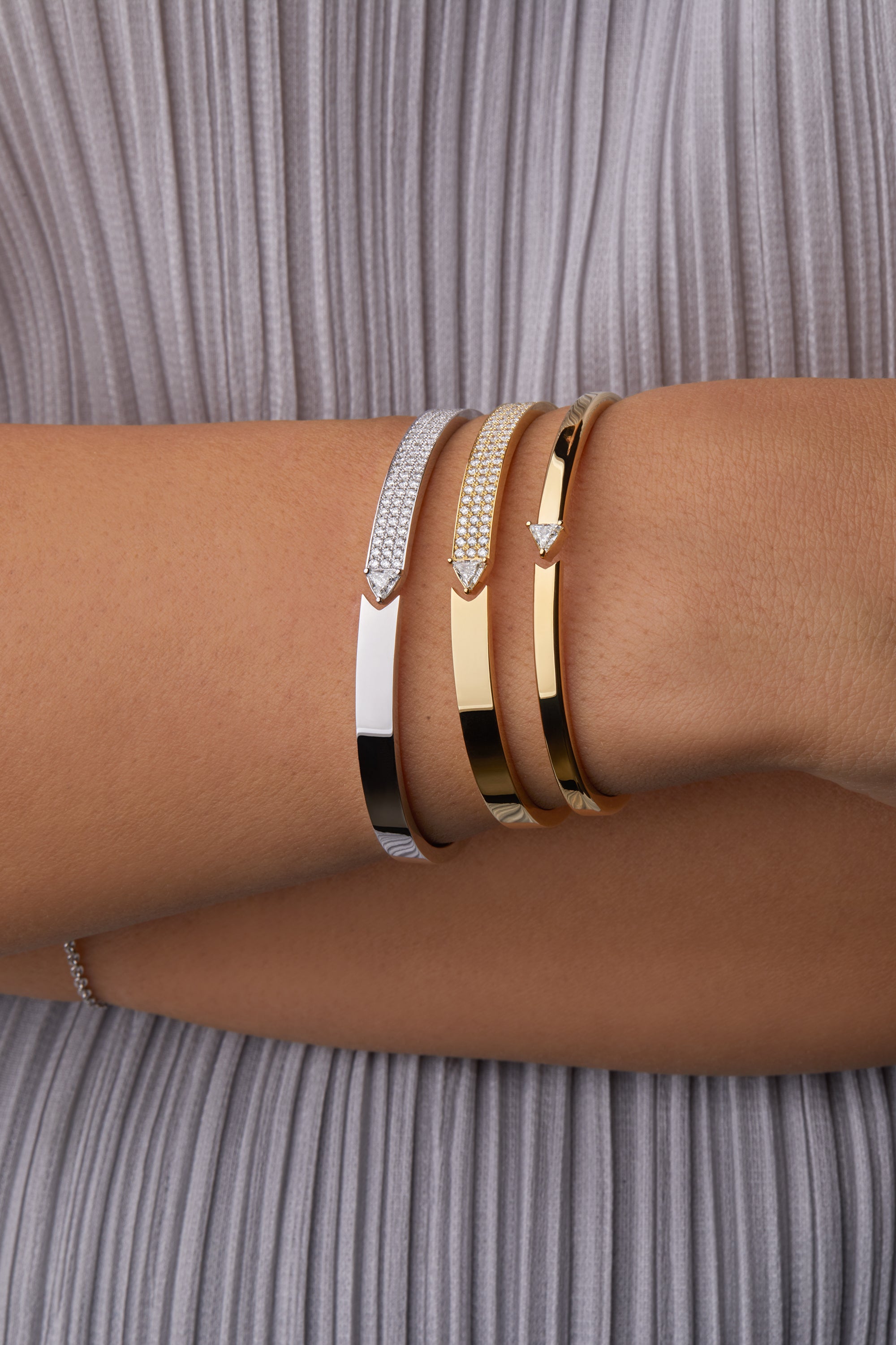 Three stellar stand still bangles portrayed on hand model.