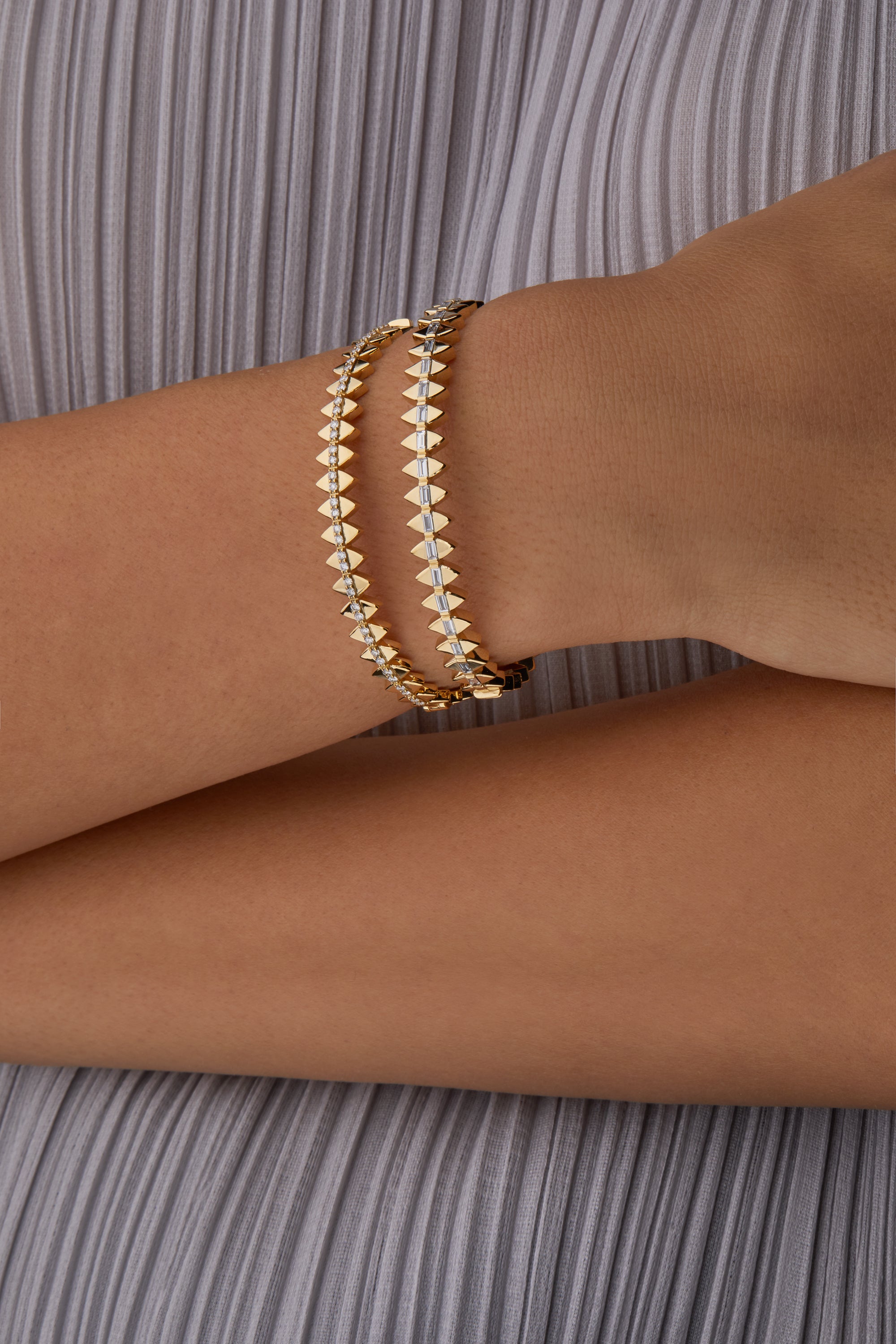 Two solidarity bangles portrayed on hand model.