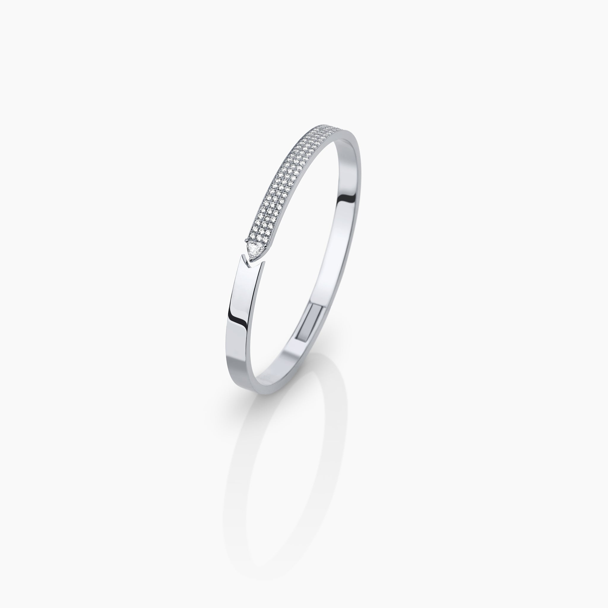 Stellar Standstill bangle in white gold featuring diamonds displayed against an off white background.