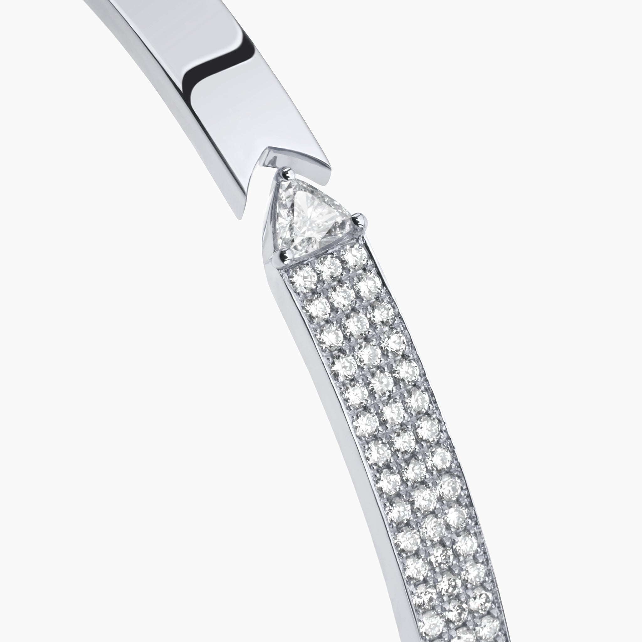 Stellar Standstill bangle in white gold featuring diamonds displayed against an off white background.