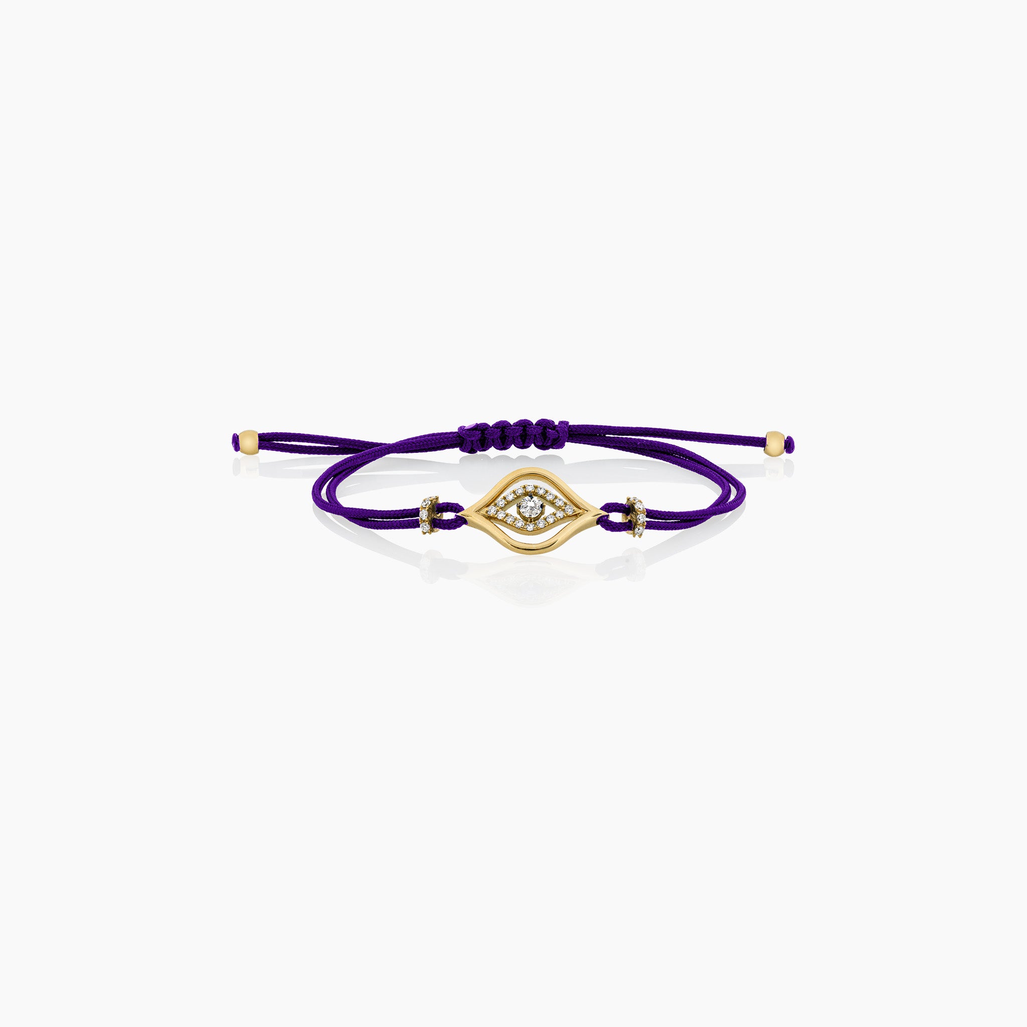 A stylish evil eye cord bracelet featuring diamonds, set on a cord, presented against an off-white background.