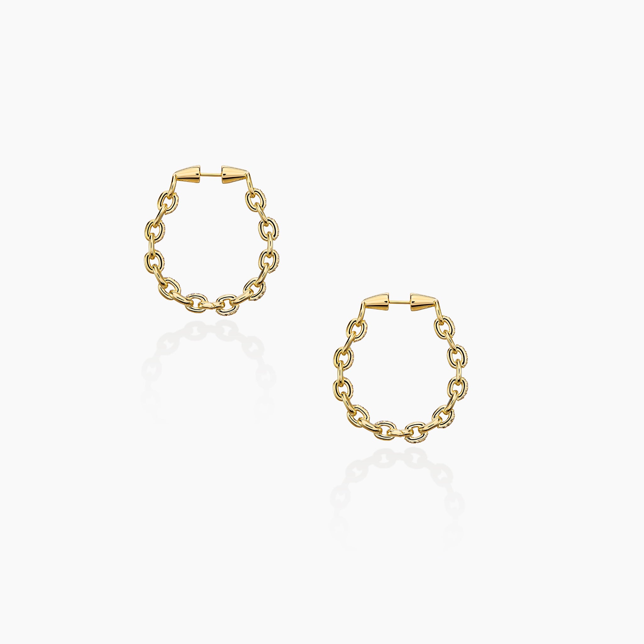 Horsebit Diamond link Hoop Earrings in yellow gold displayed on an off white background.