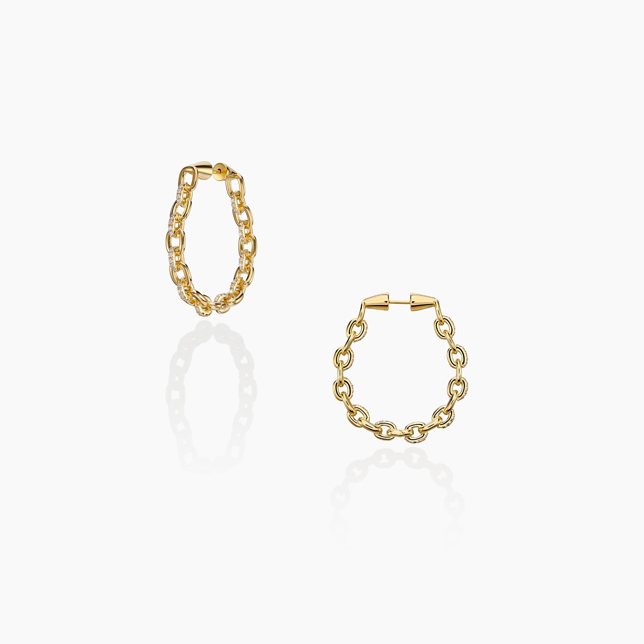 Horsebit Diamond link Hoop Earrings in yellow gold displayed on an off white background.