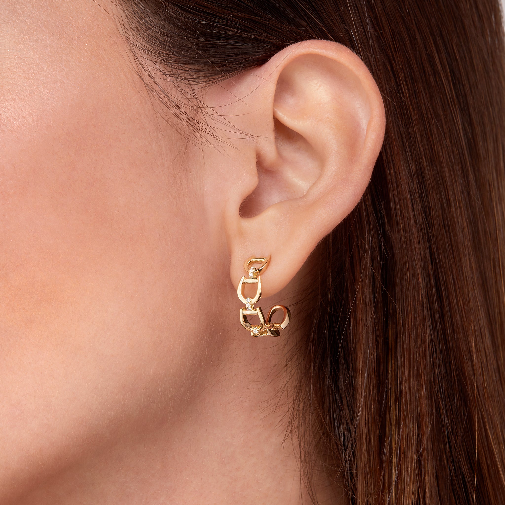 Fulanda Everyday Horsebit Earrings in yellow gold displayed on model