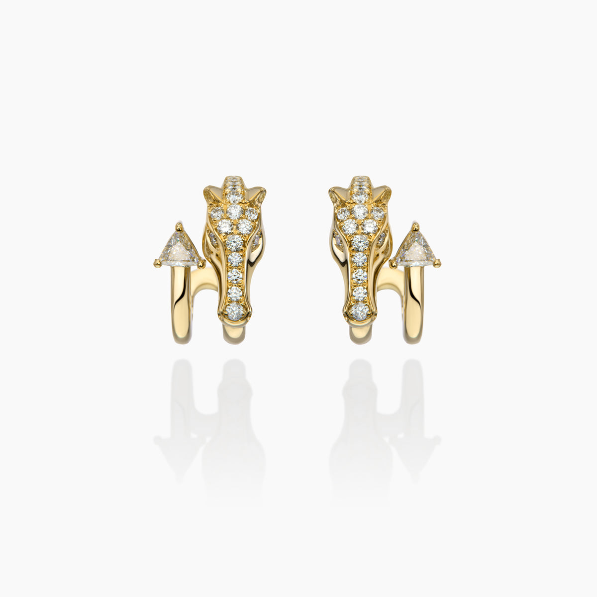 Gold horse earrings with diamond accents on a white background