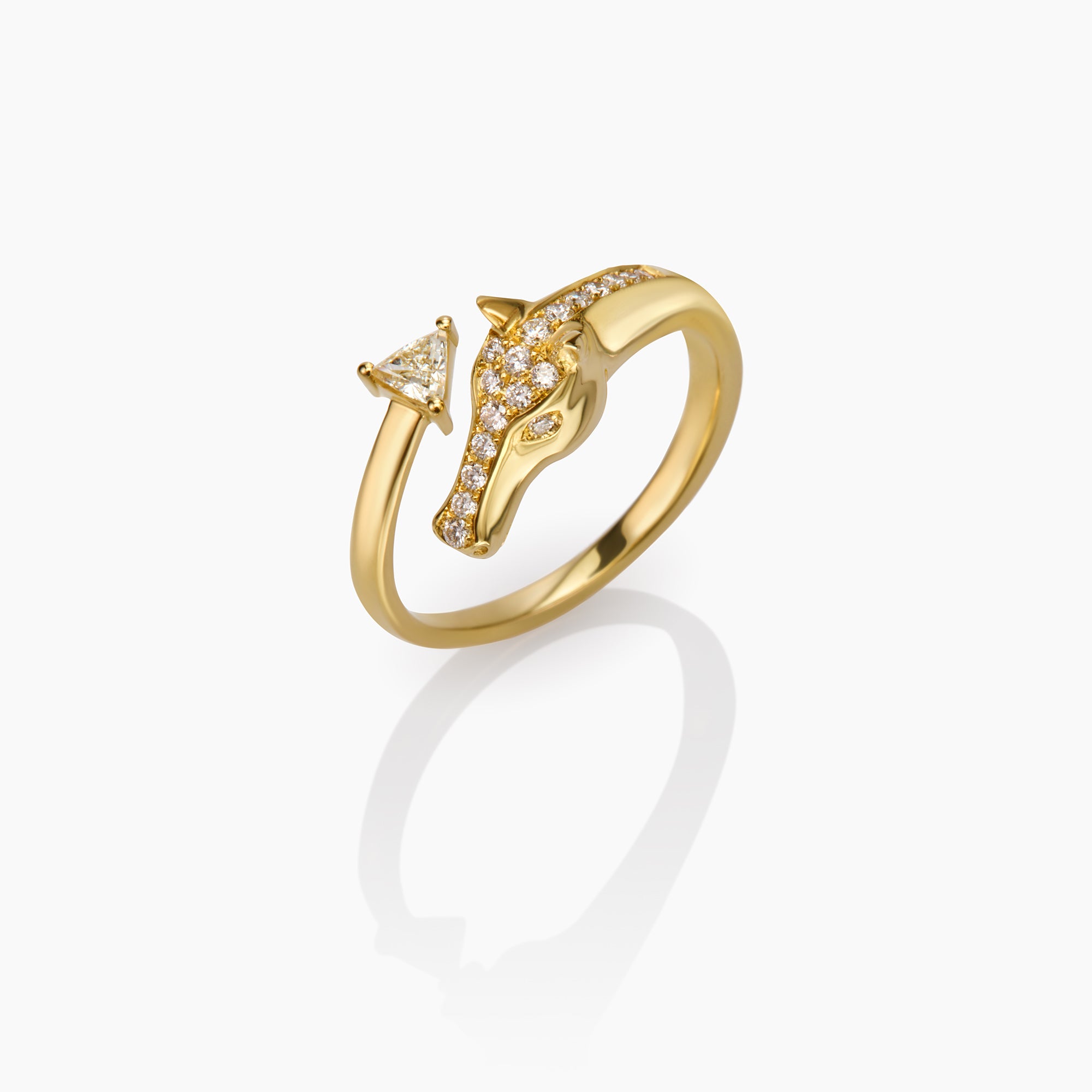 Gold ring with a horse design on a white background