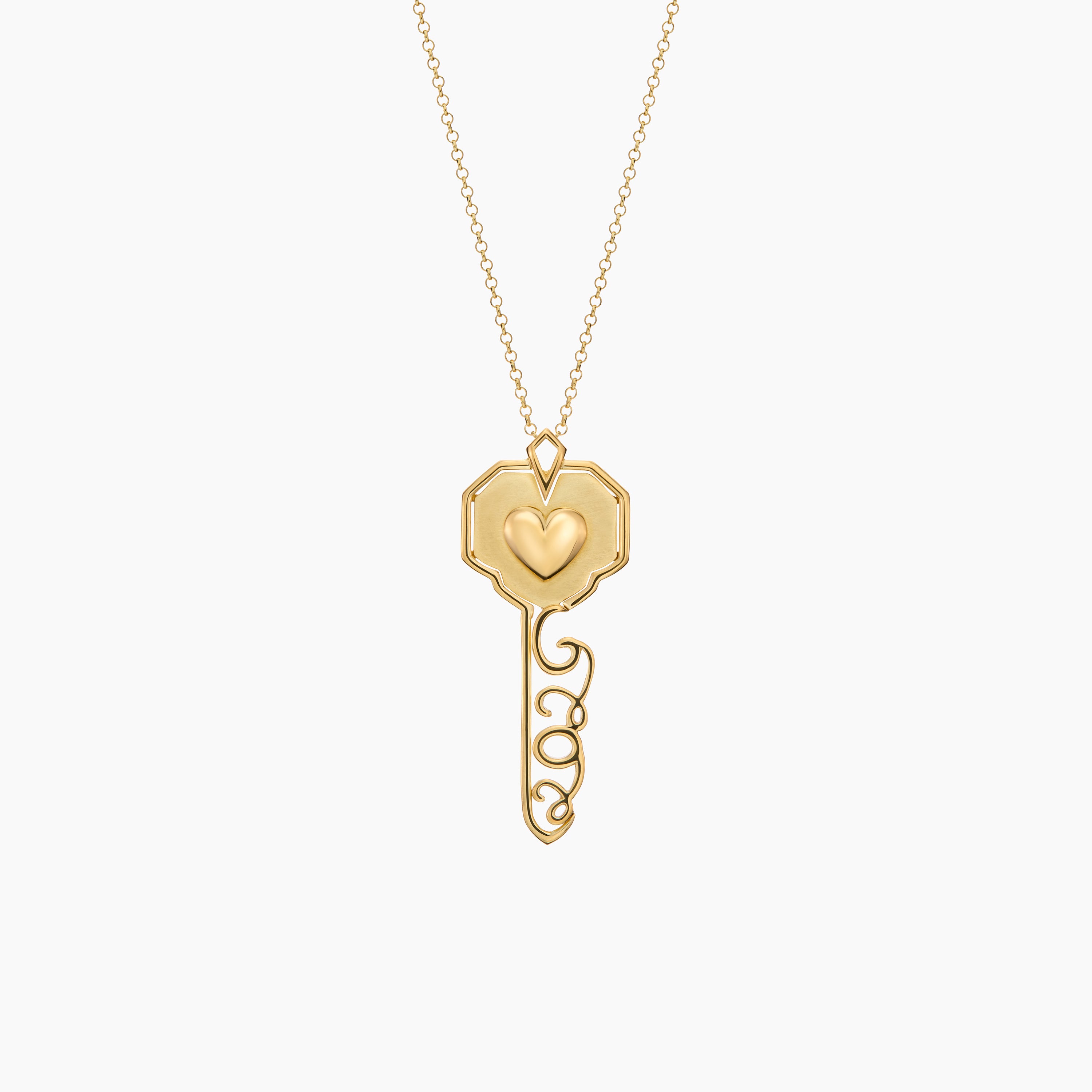 Gold key-shaped pendant with a heart on a white background