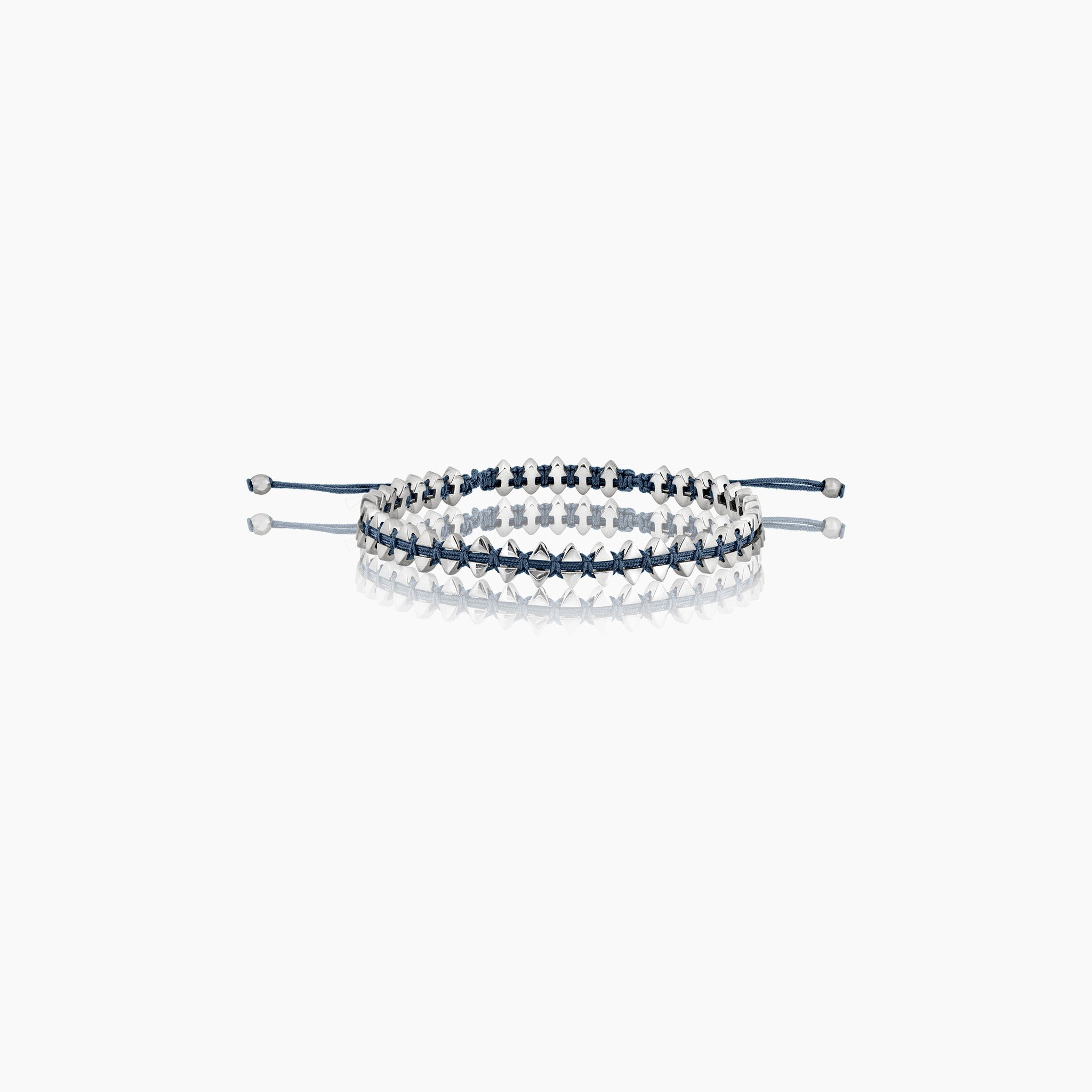 Men's anchor bracelet with dual-sided design, featuring anchor motifs on one side and boat-inspired triangles on the other displayed on off white background.