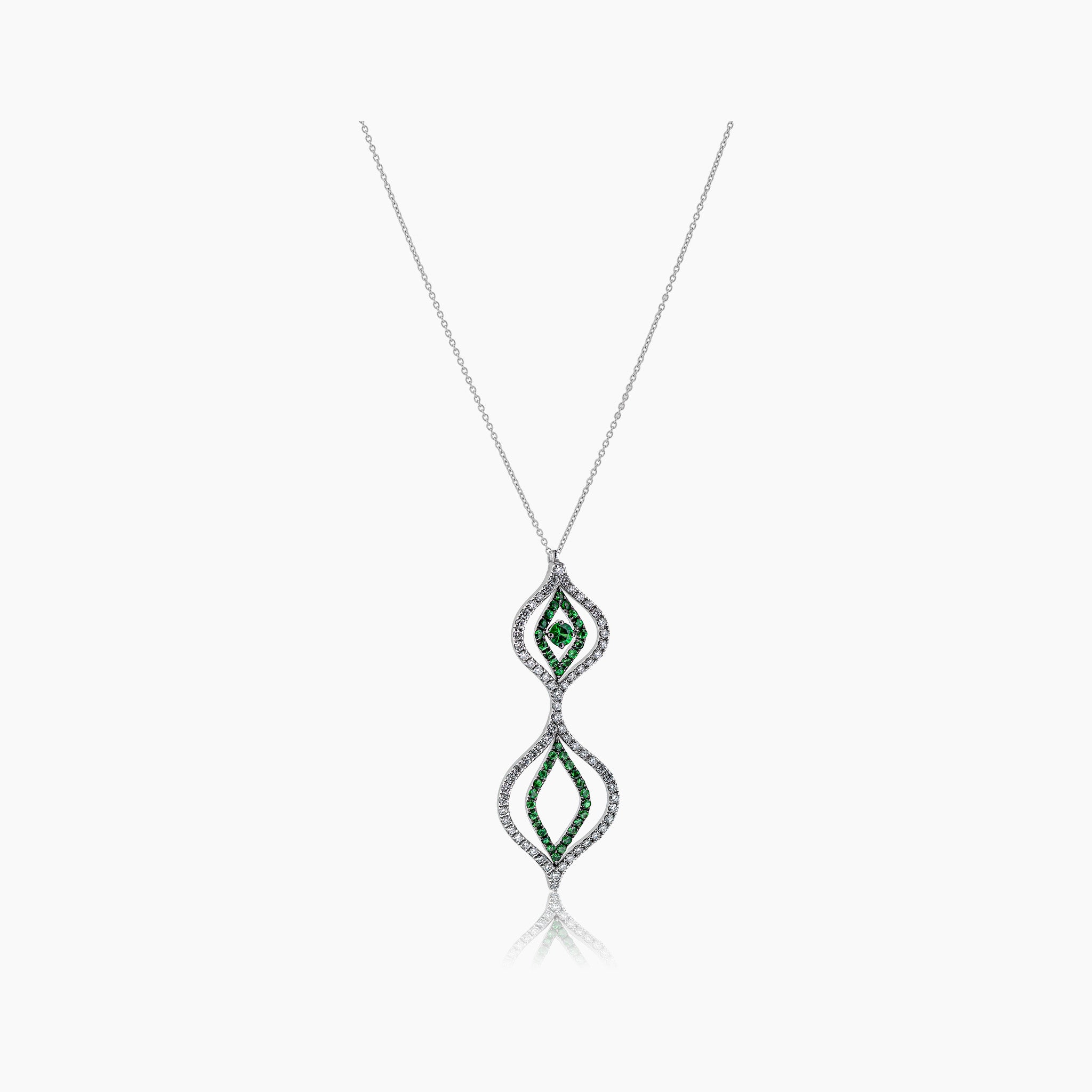 Diamond and tsavorite Venus Versatile Hanging Earrings illustrating the pendant on an off white background.