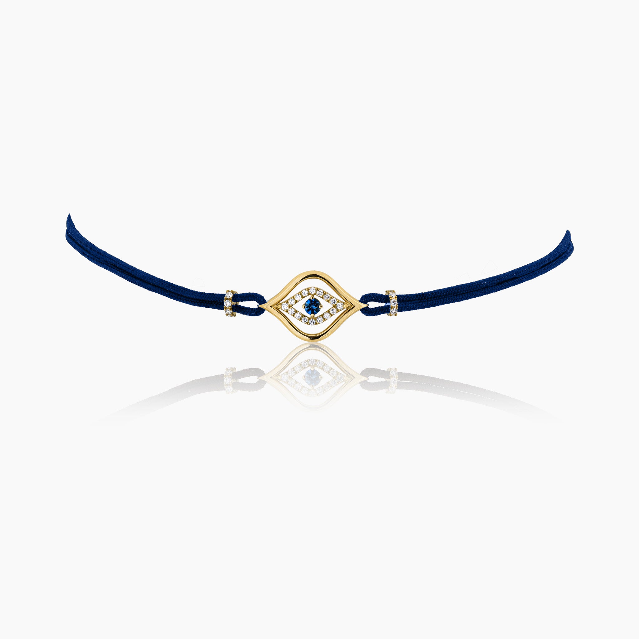 A stylish evil eye choker necklace in a navy blue cord featuring a central sapphire surrounded by diamonds, set on a cord, presented against an off-white background.