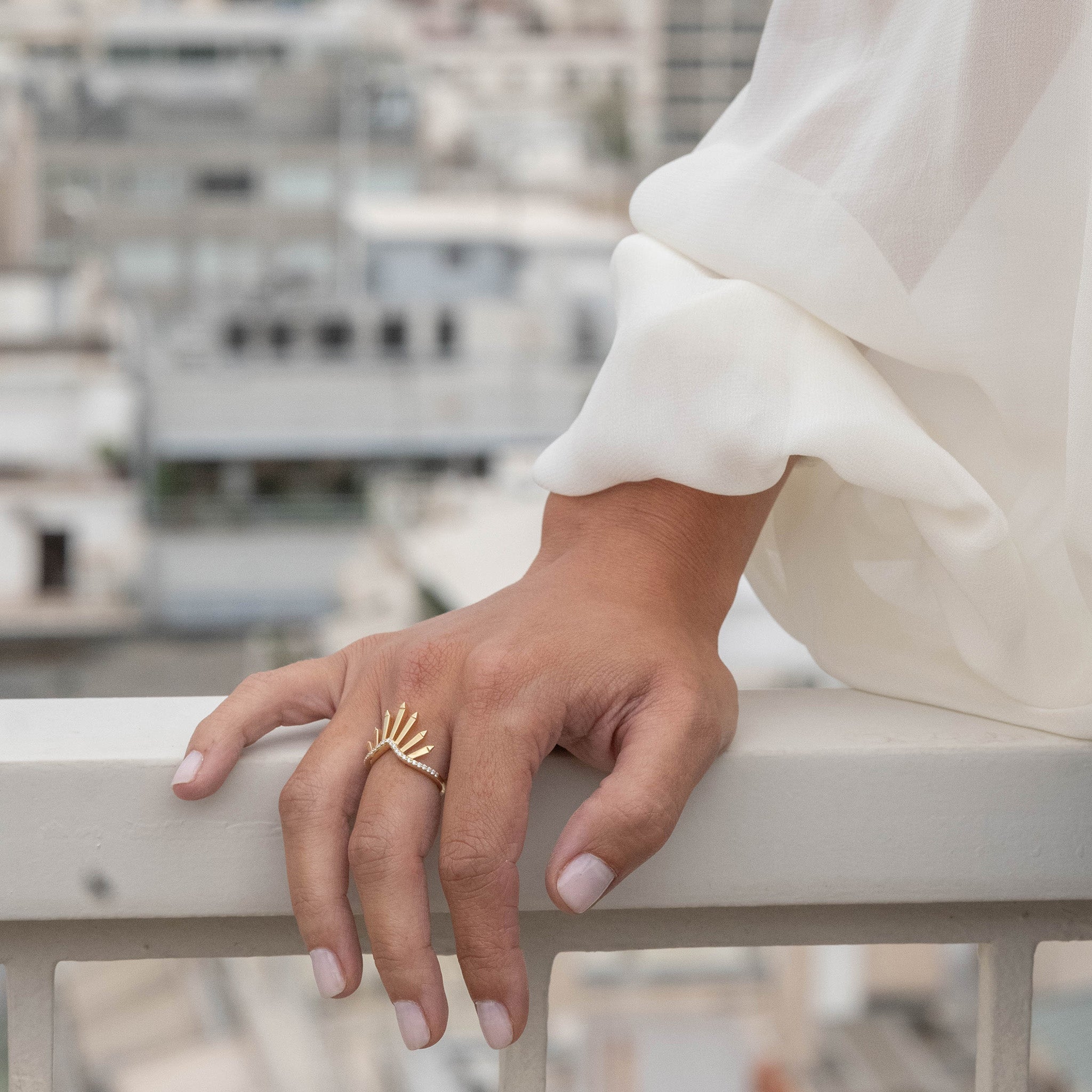Yellow Gold Ring: Featuring radiant sunburst motifs adorned with diamonds, showcased on hand model.