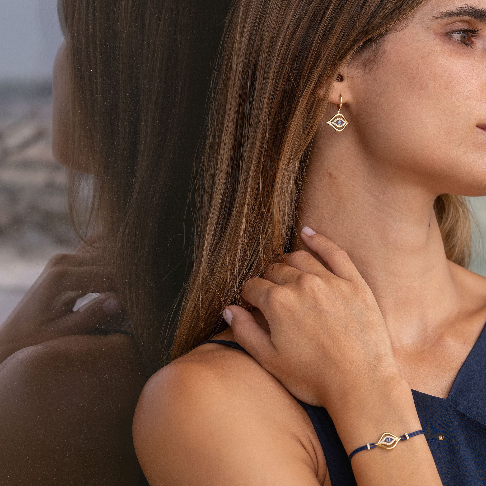 Exquisite fine jewellery diamond and sapphire earrings and bracelet on model.