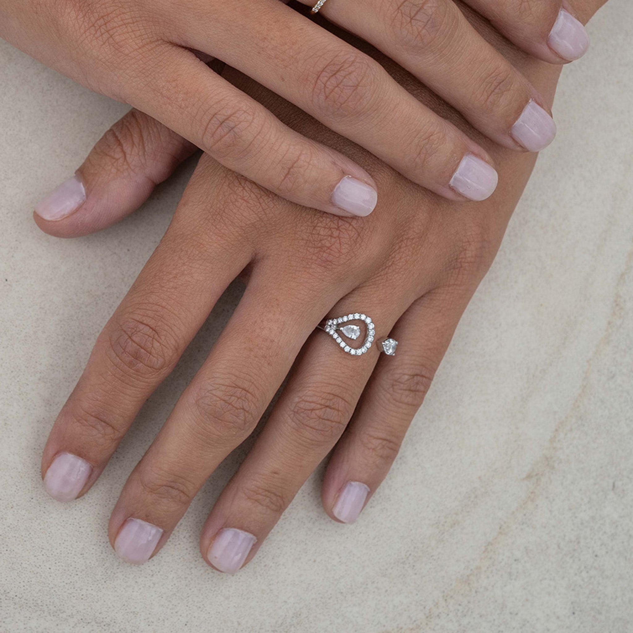 A stunning ring adorned with dazzling diamonds, displayed on hand model.