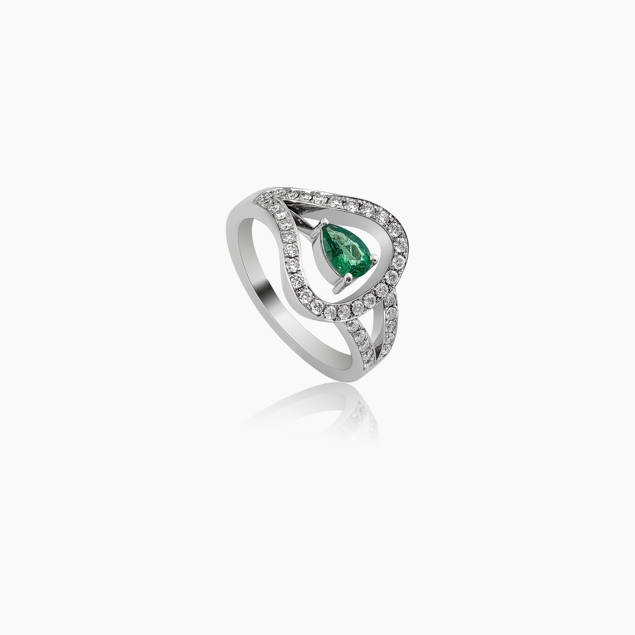 Anagenesis ring: Featuring a stunning Zambian emerald at its center, encircled by glistening diamonds, set in white gold, showcased on an off-white background.