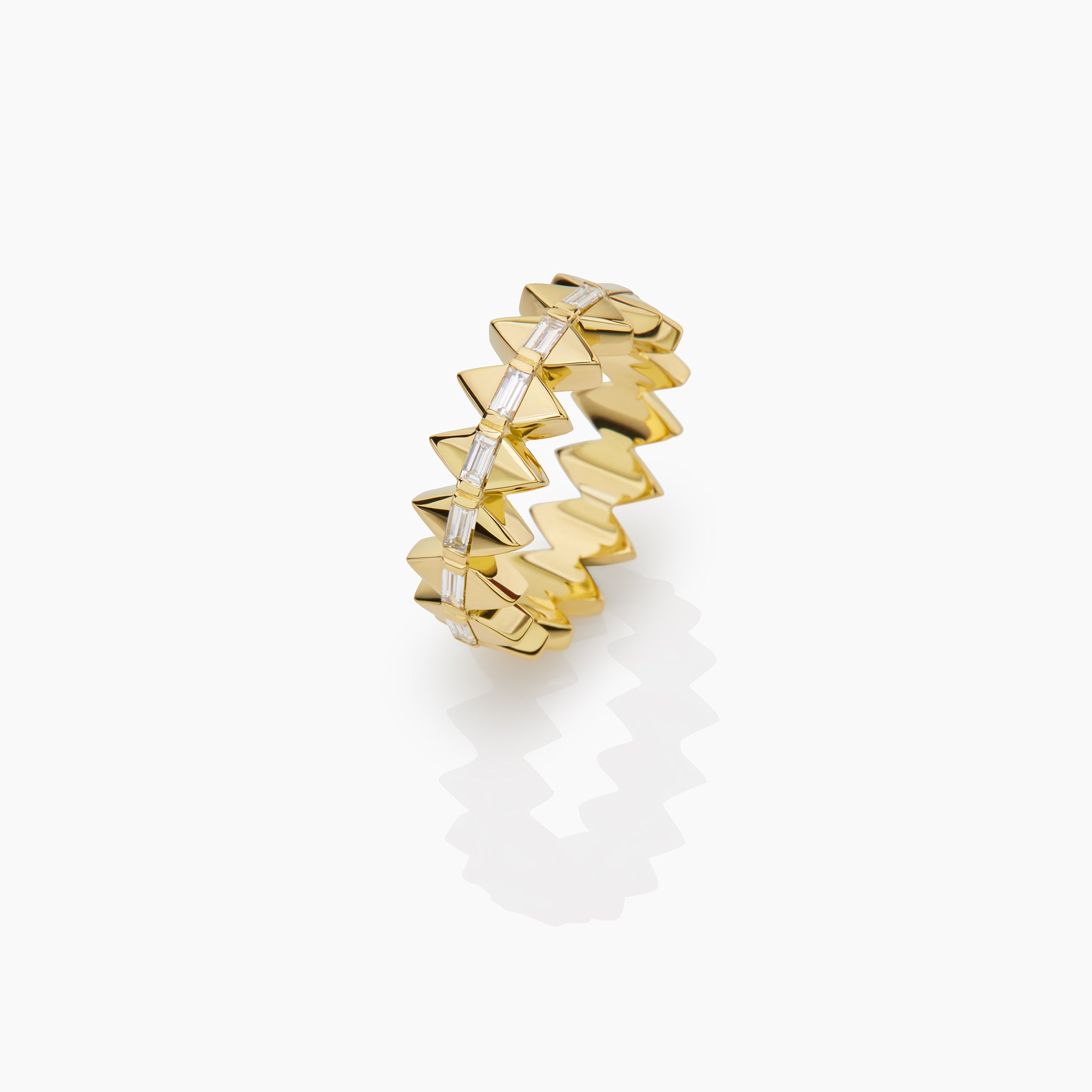 Yellow Gold Solidarity ring with baguette diamonds displayed on off white background 