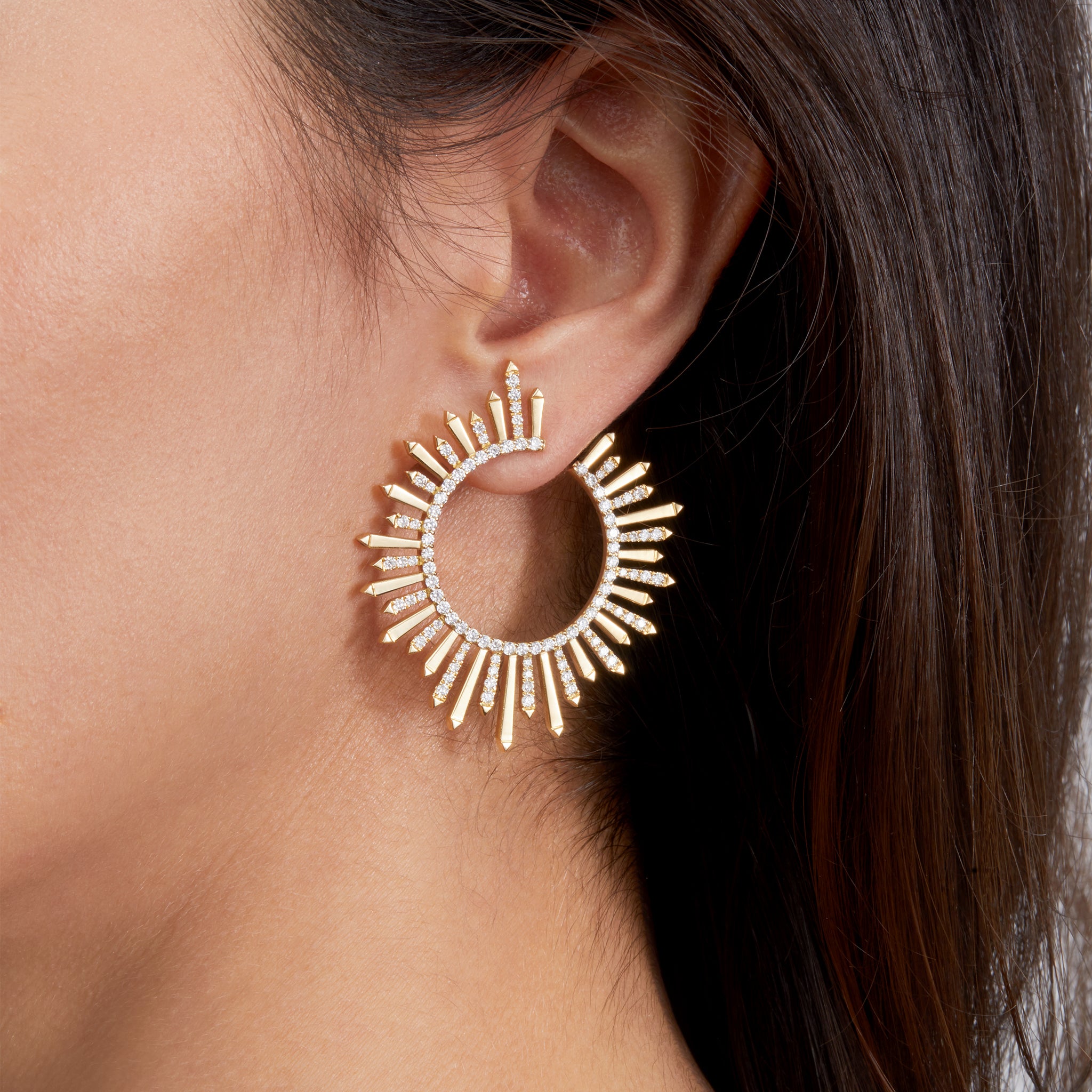 Earrings in yellow gold with diamonds on model.