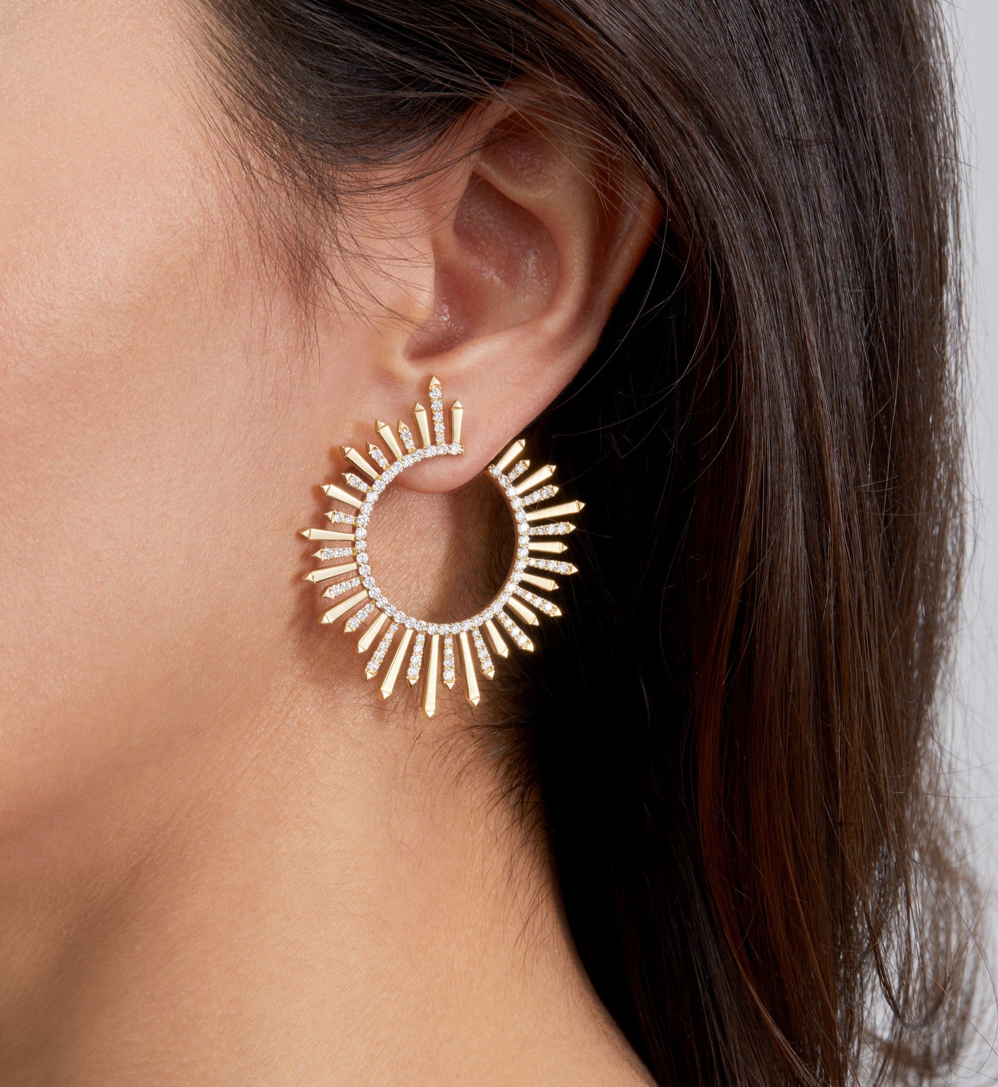 Earrings in yellow gold with diamonds on model.