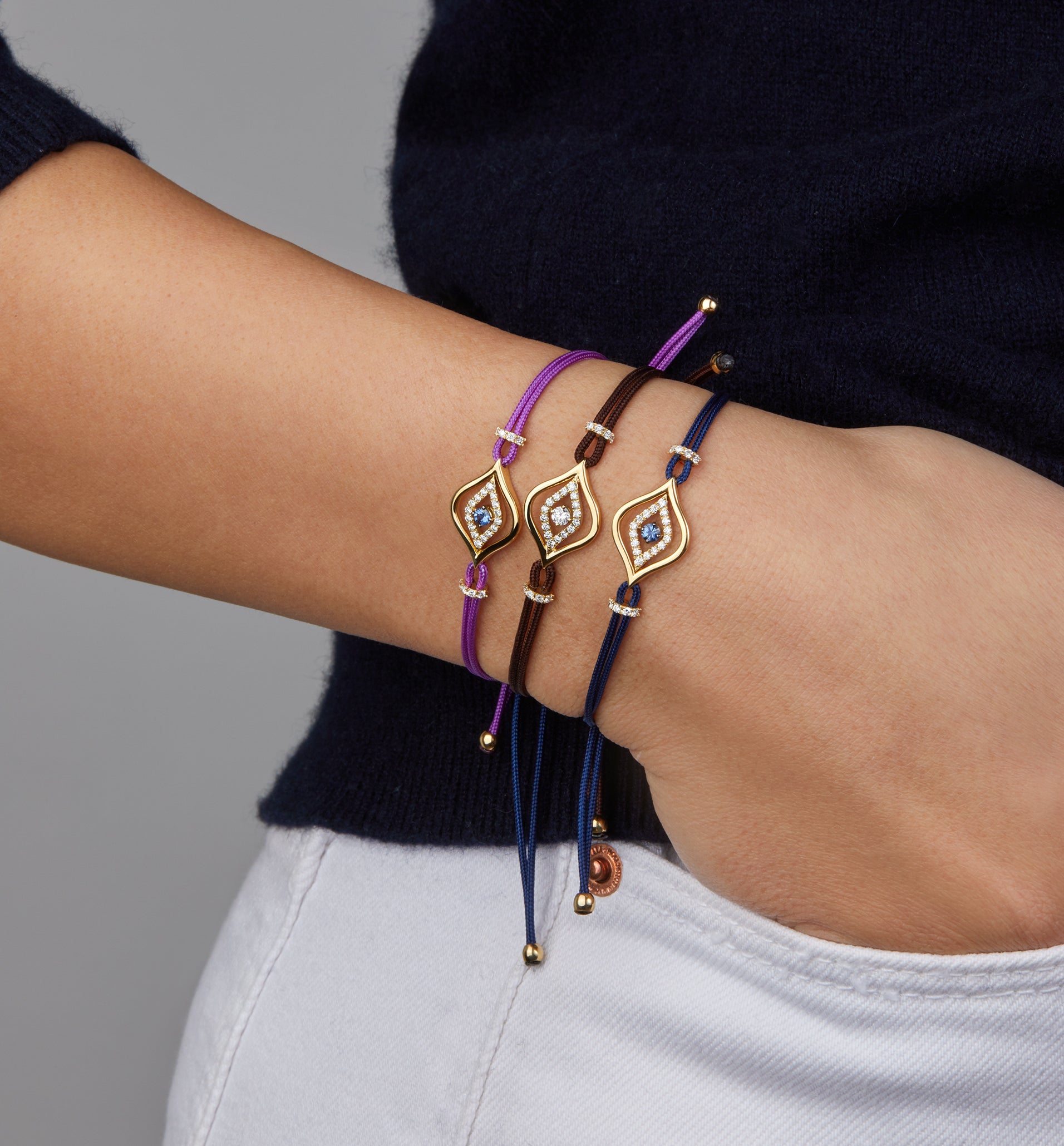 Evil eye cord bracelets portrayed on hand model.