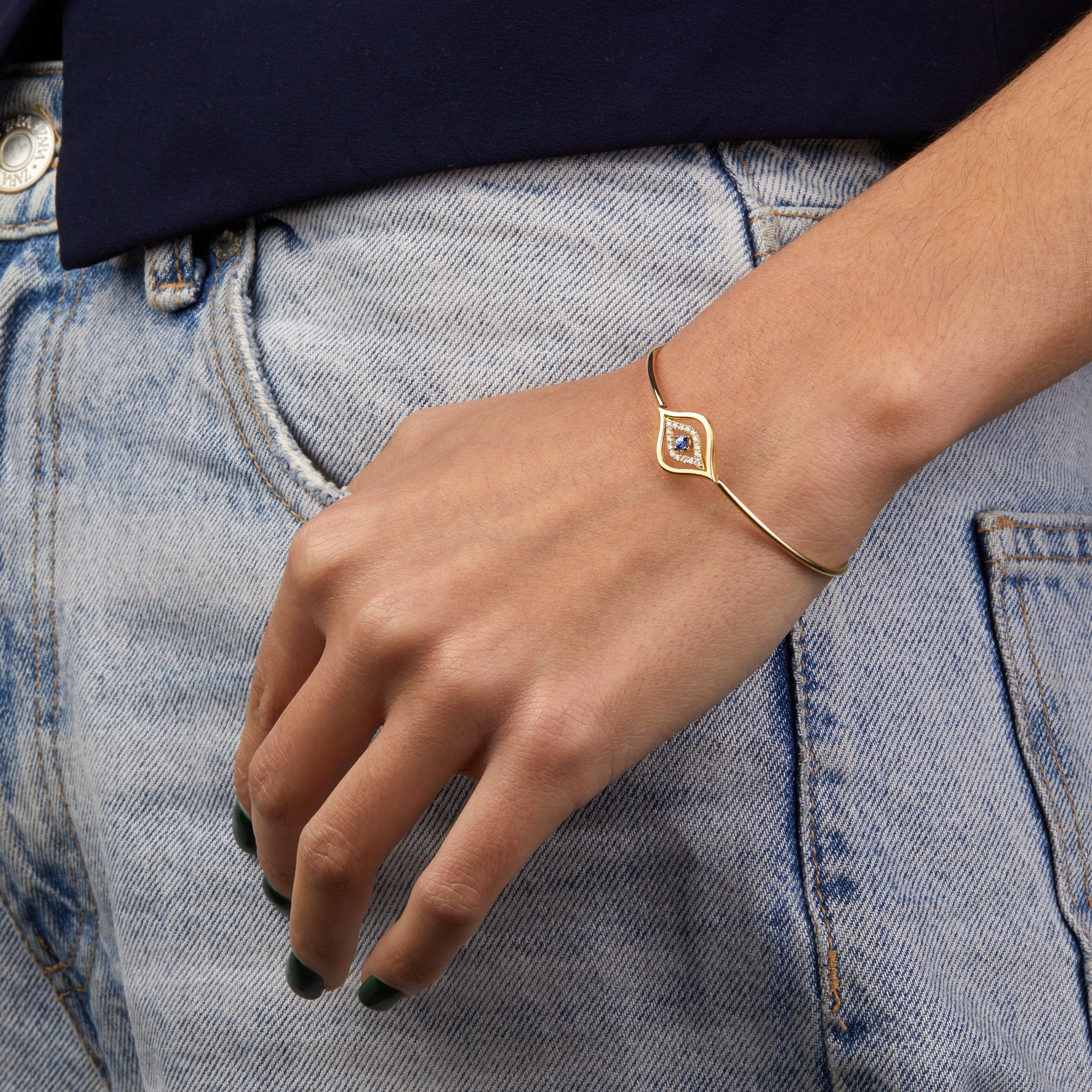 Evil Eye bangle portrayed on model wearing denim.