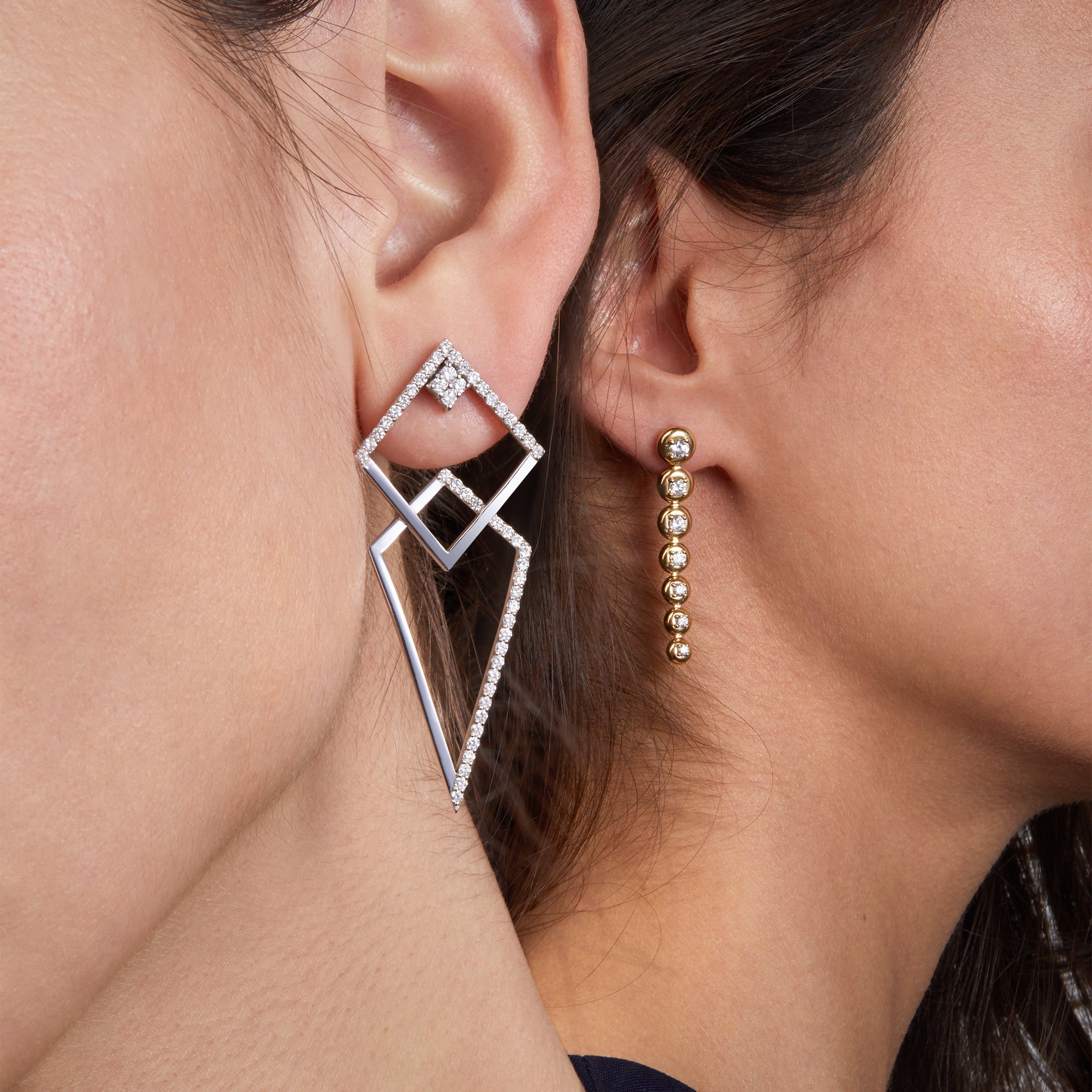 Thunder white gold earrings with star trail earrings illustrated on two different models that shows their versatility and how they can be worn into one design.