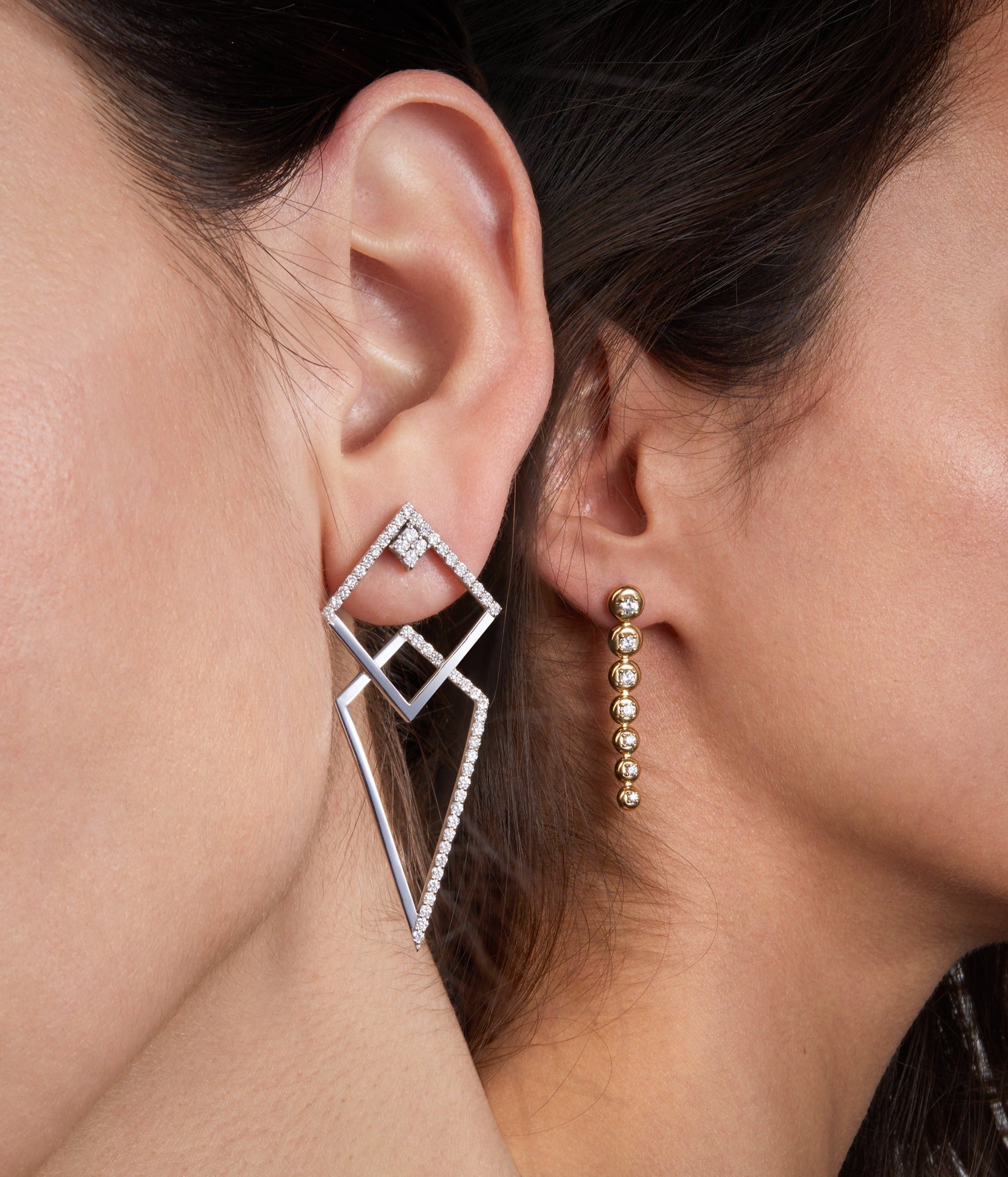 Thunder white gold earrings with star trail earrings illustrated on two different models that shows their versatility and how they can be worn into one design.