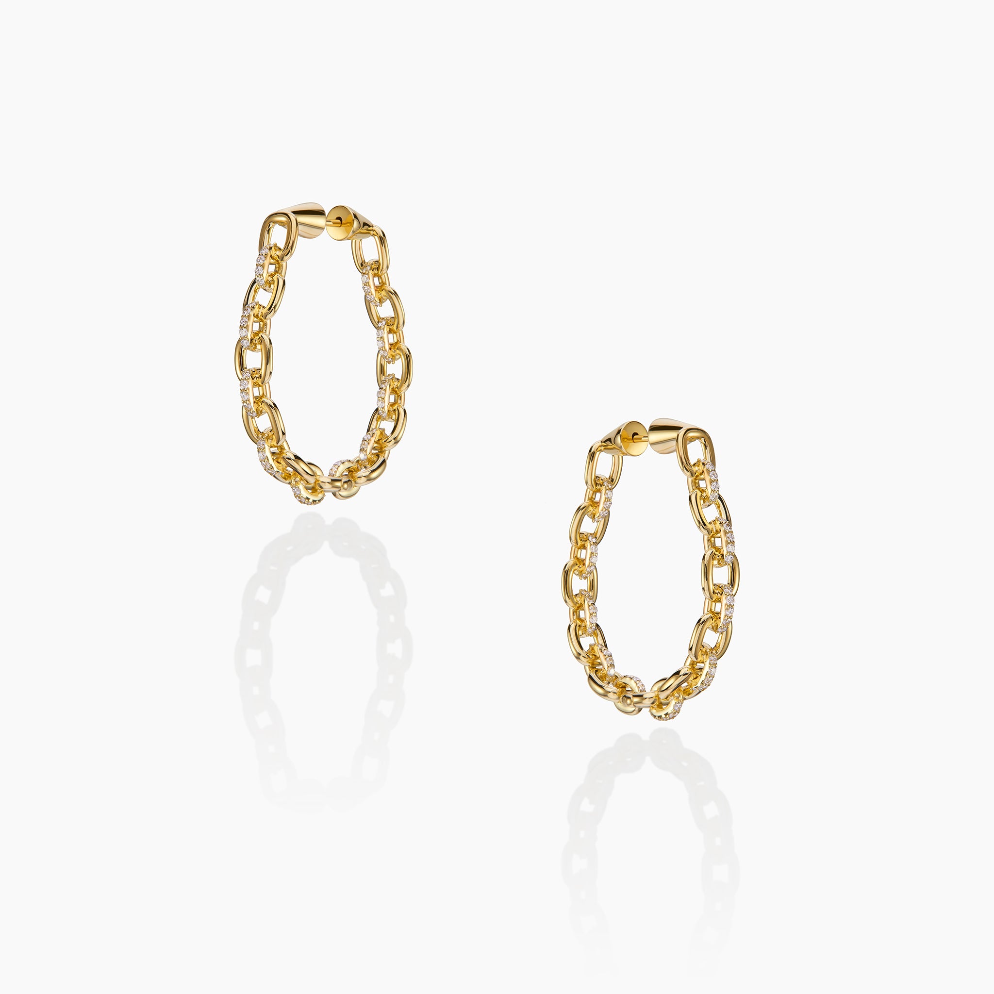 Horsebit Diamond link Hoop Earrings in yellow gold displayed on an off white background.