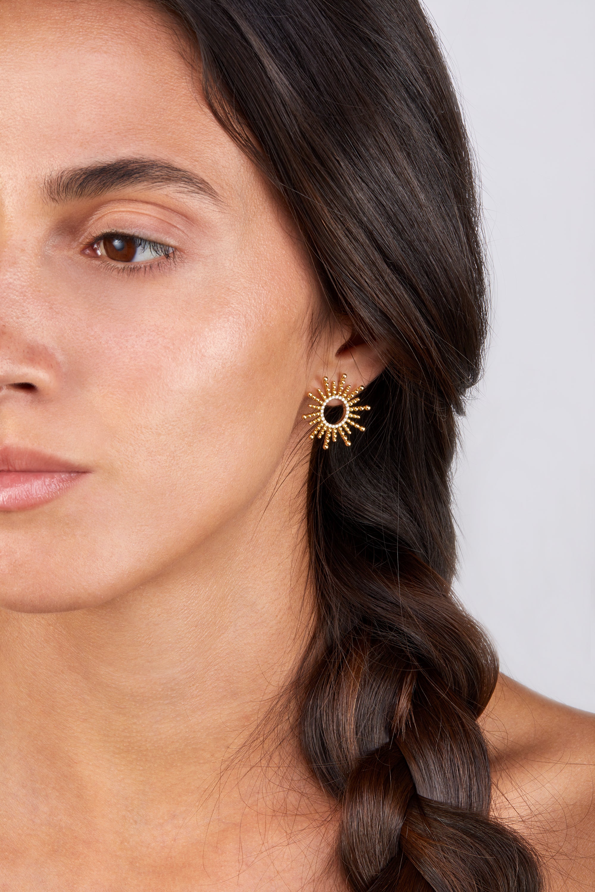 Sea urchin-inspired yellow gold earrings with diamonds, showcased on model