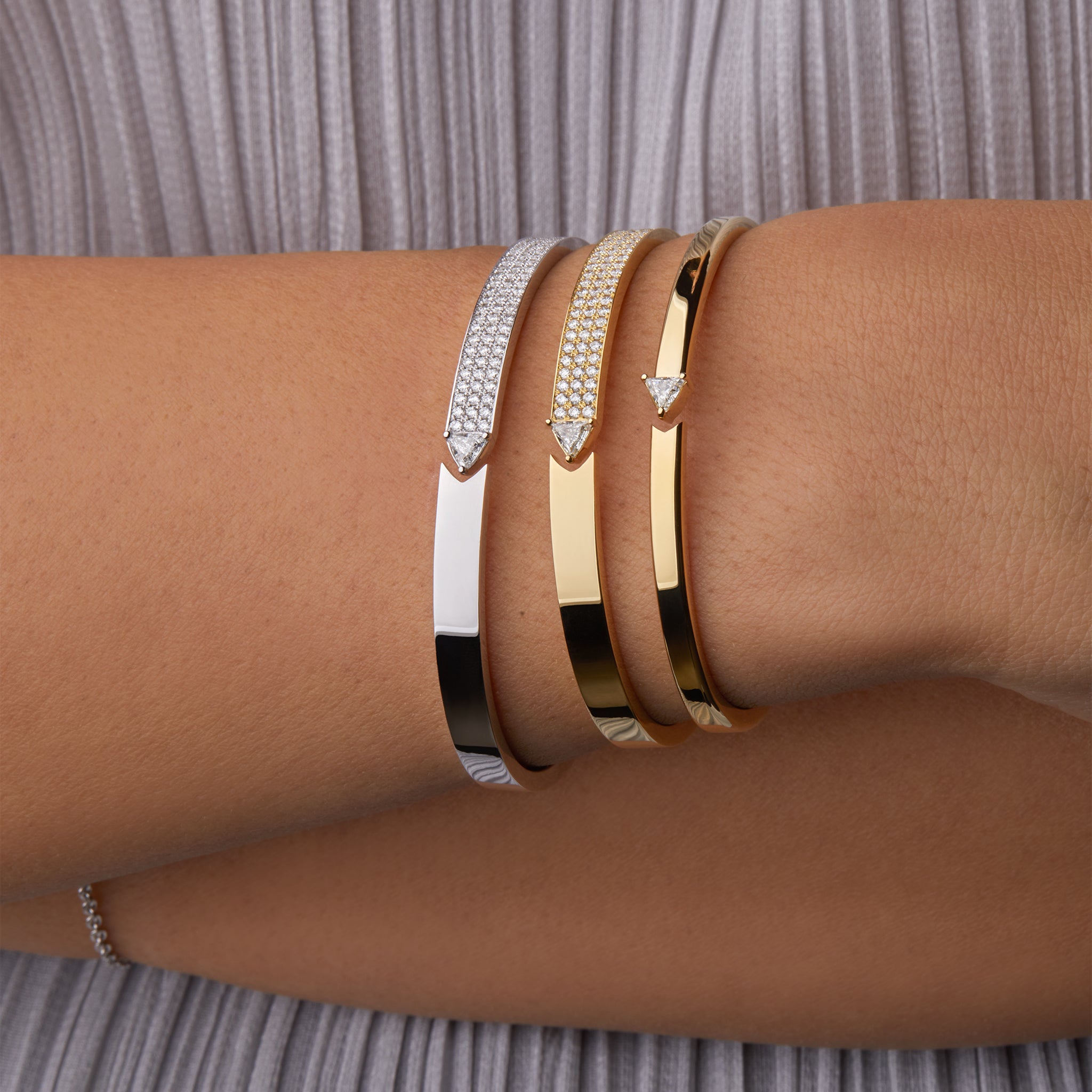 Stellar Standstill bangle in yellow and white gold featuring diamonds  displayed on hand model. 
