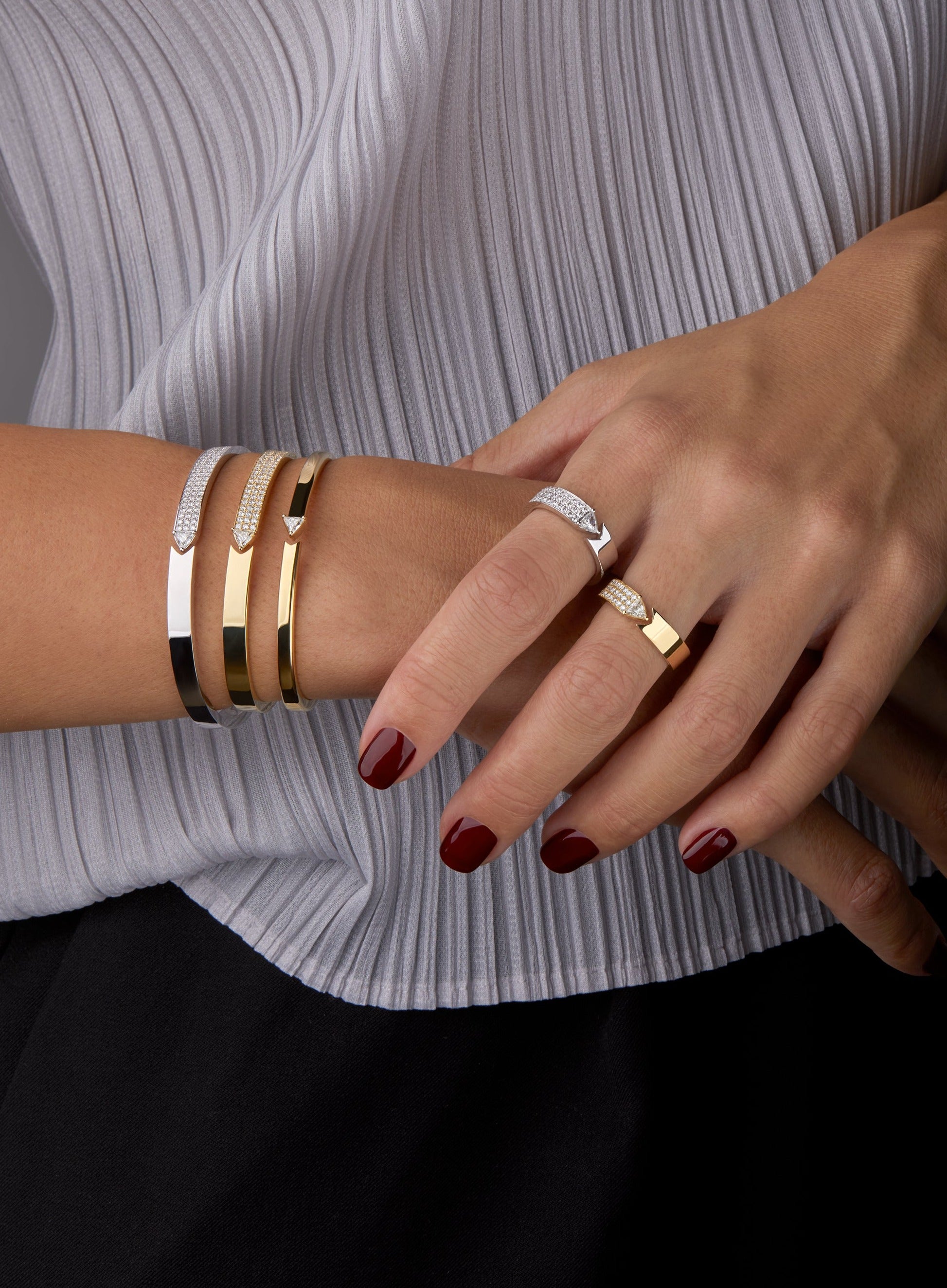 Stellar Standstill rings and bangles featured on a hand model. 