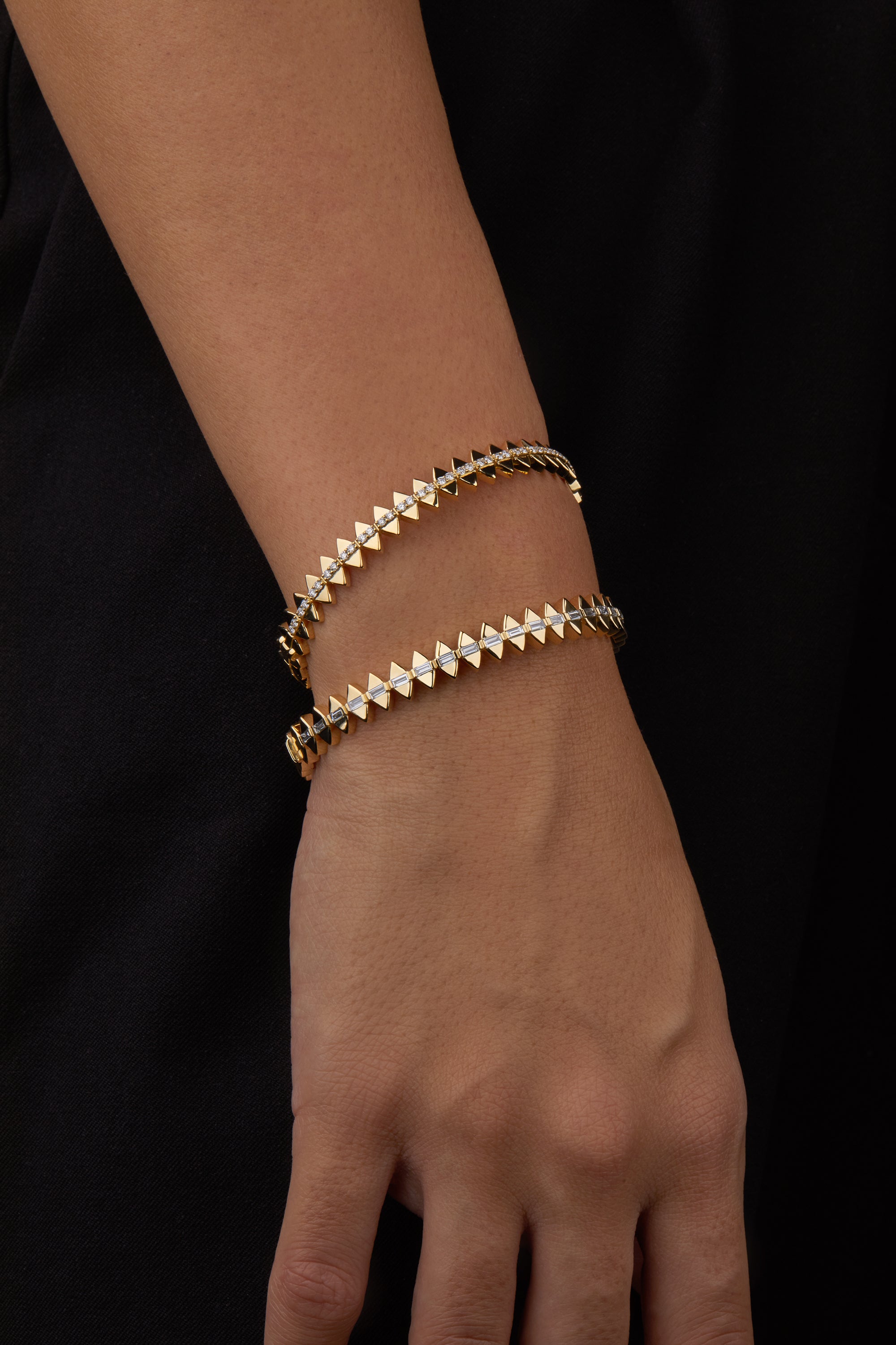 Two solidarity bangles portrayed on hand model.