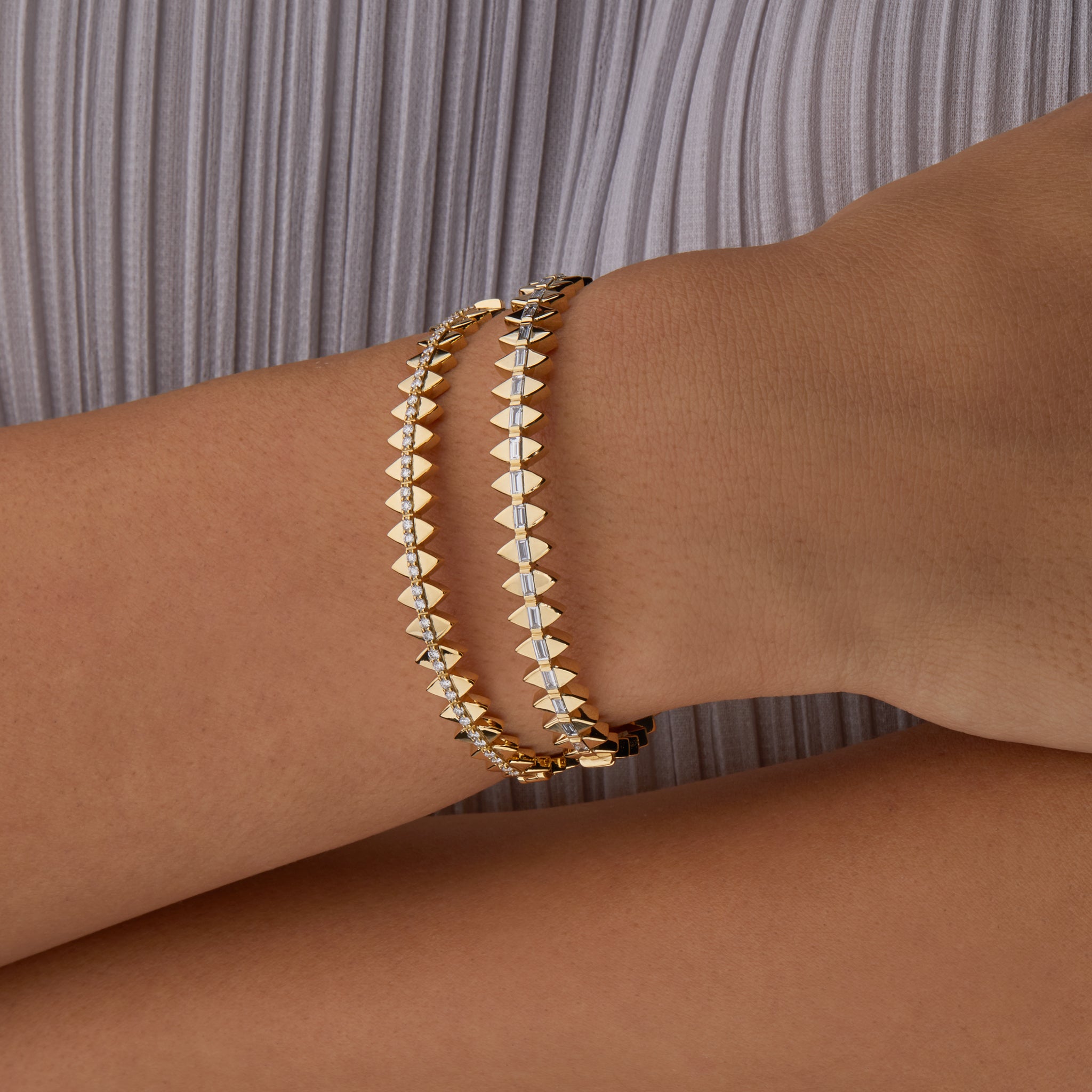 Two solidarity bangles portrayed on hand model.