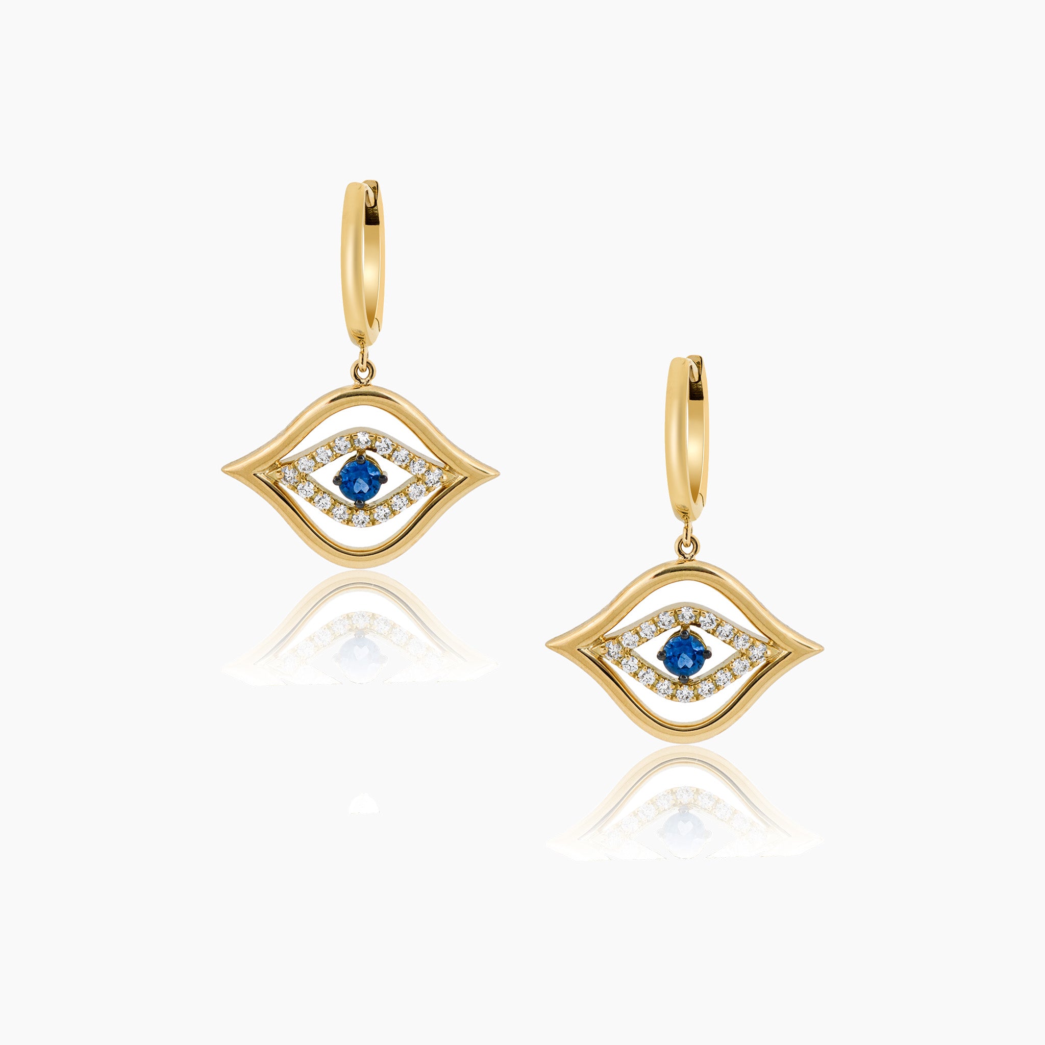 Exquisite fine jewellery featuring stunning diamond and sapphire earrings against an elegant off-white backdrop.