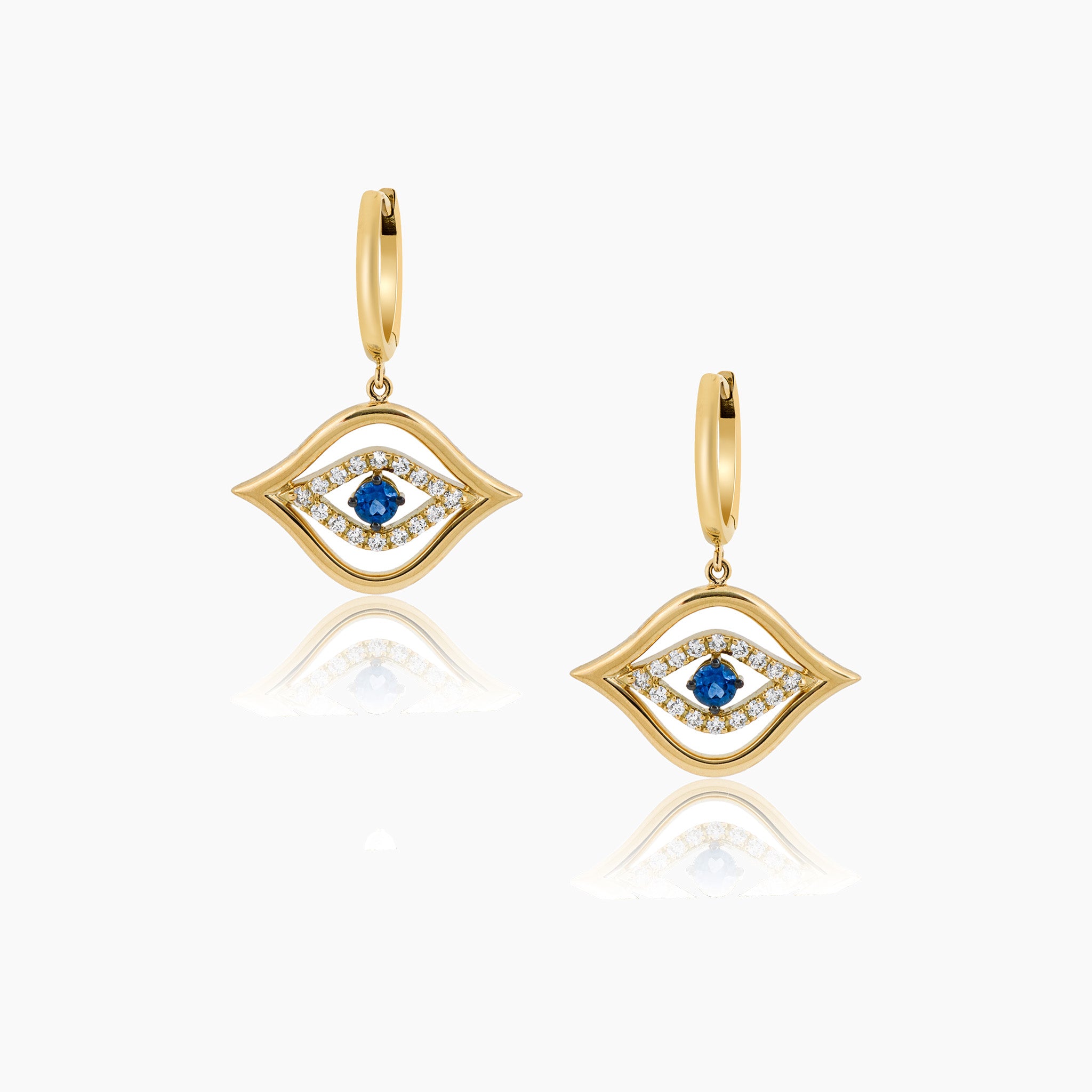 Exquisite fine jewellery featuring stunning diamond and sapphire earrings against an elegant off-white backdrop.