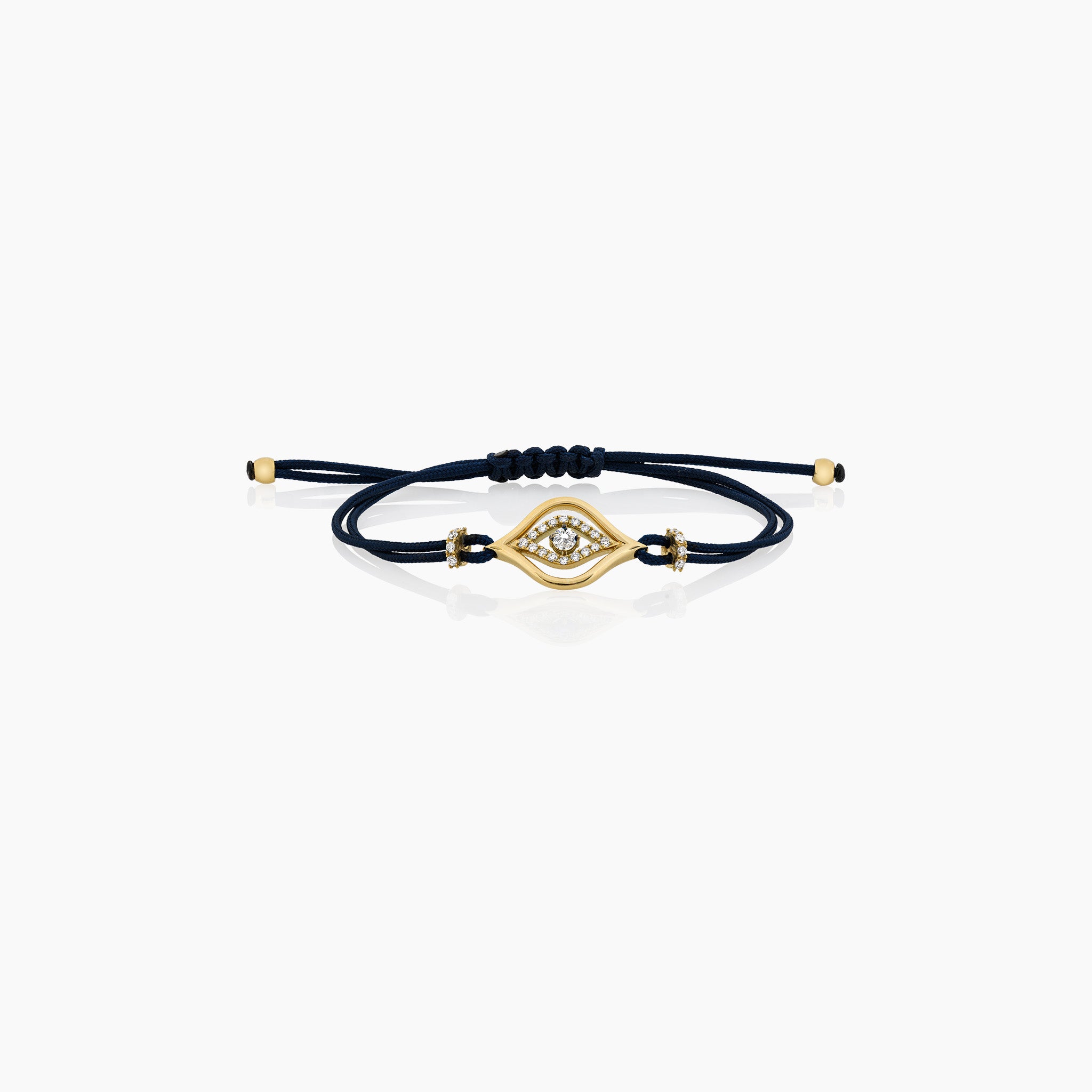 A stylish evil eye cord bracelet featuring diamonds, set on a cord, presented against an off-white background. 