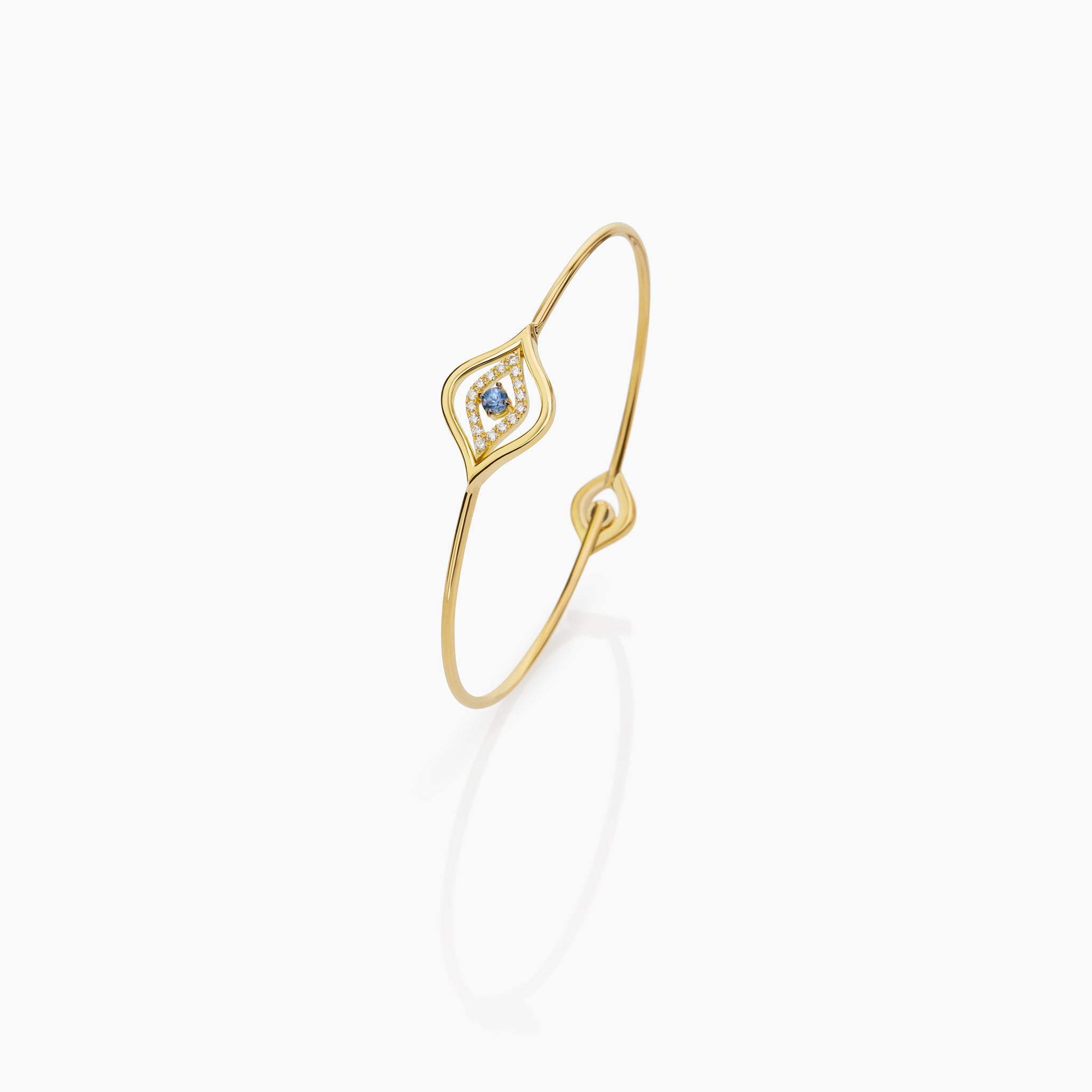Evil Eye Bangle displayed on an off white background. 