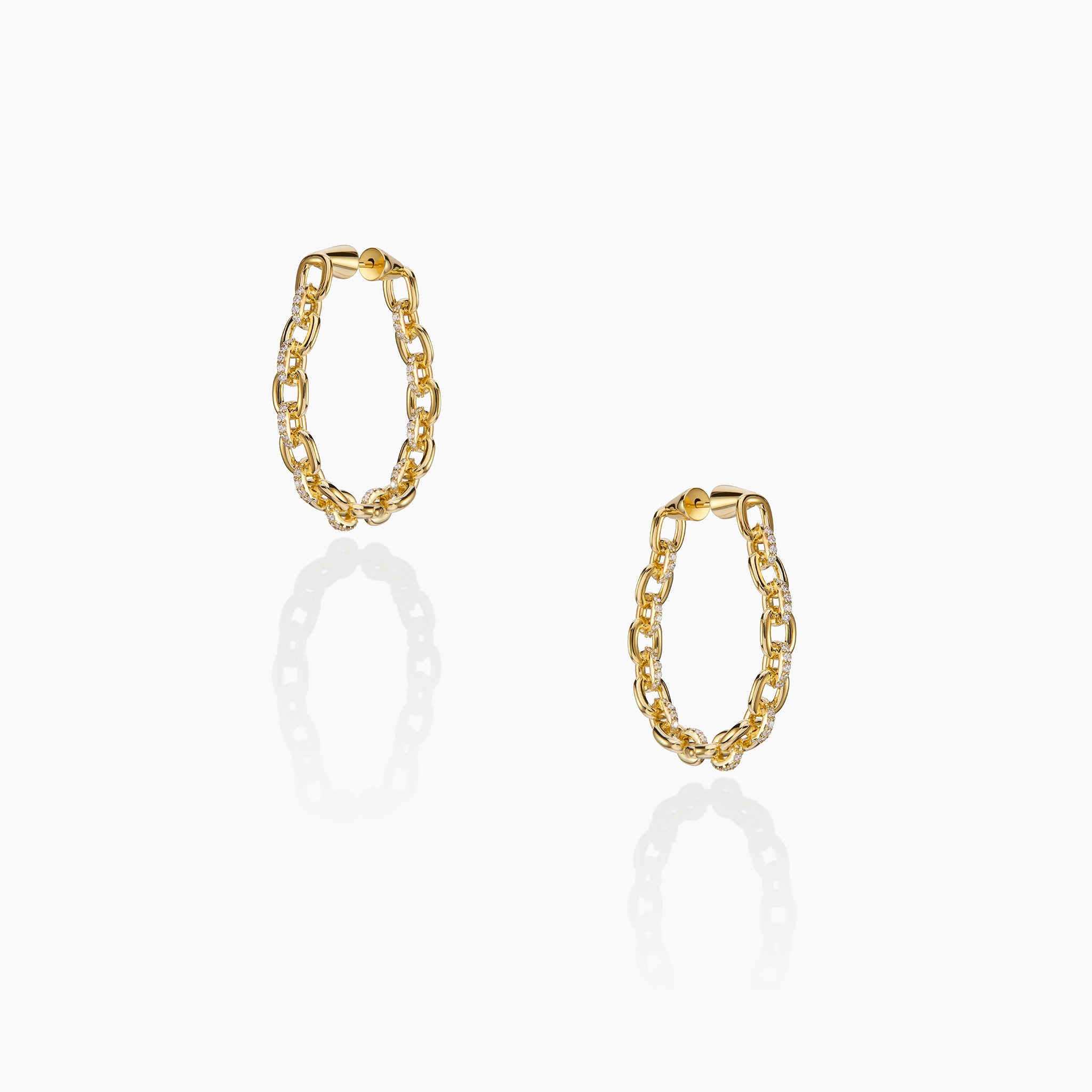 Horsebit Diamond link Hoop Earrings in yellow gold displayed on an off white background.
