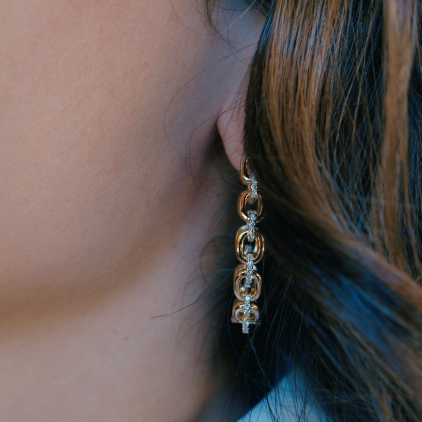 Horsebit Diamond link Hoop Earrings in yellow gold displayed on model
