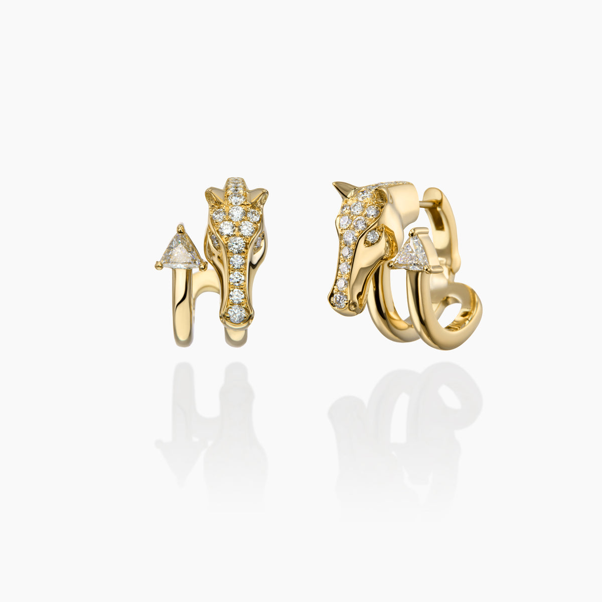 Gold horse earrings with diamond accents on a white background
