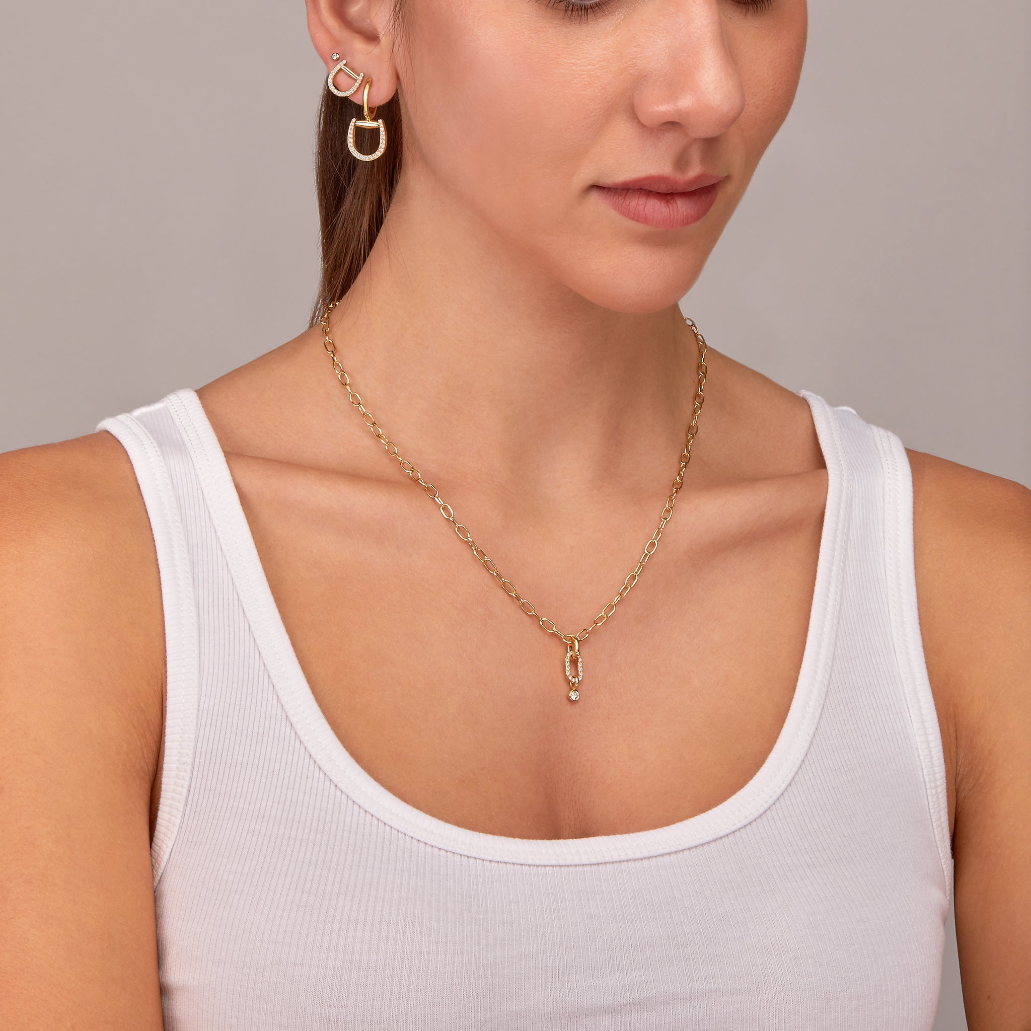 Fulanda Horsebit earrings displayed on model along with the convertible link necklace 
