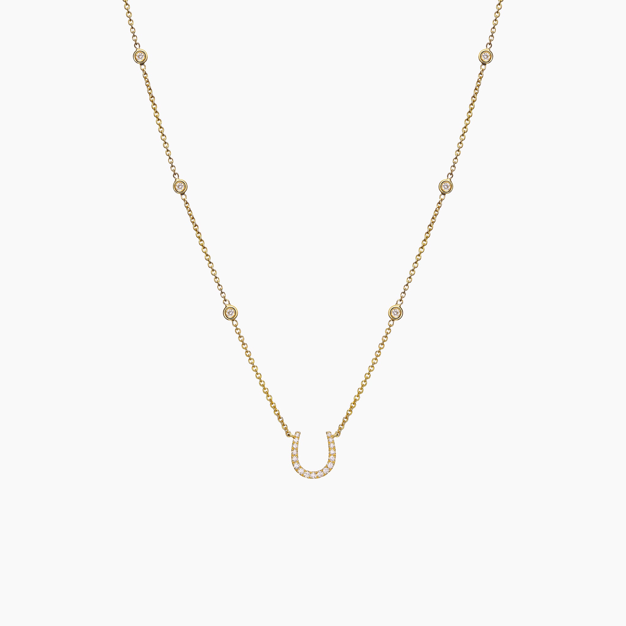 Fulanda Horseshoe Diamond Necklace  in yellow gold displayed on an off white background.
