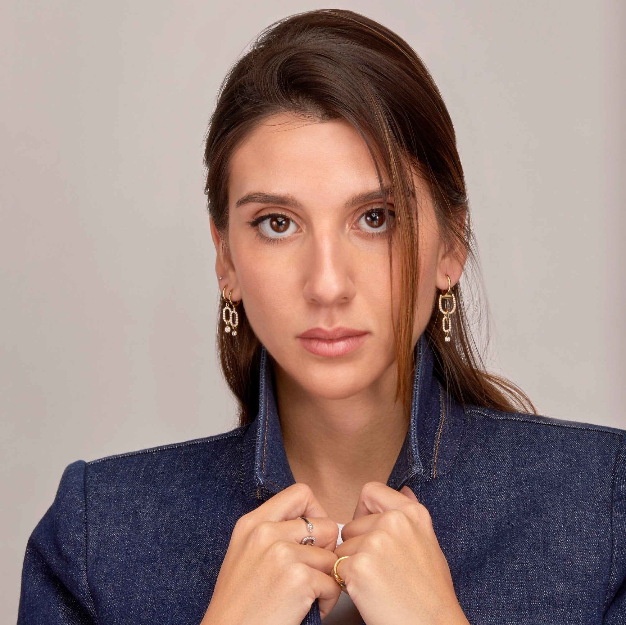 Fulanda Link Diamond Earrings stacked &  Convertible Horsebit Hoop Earrings displayed on model 