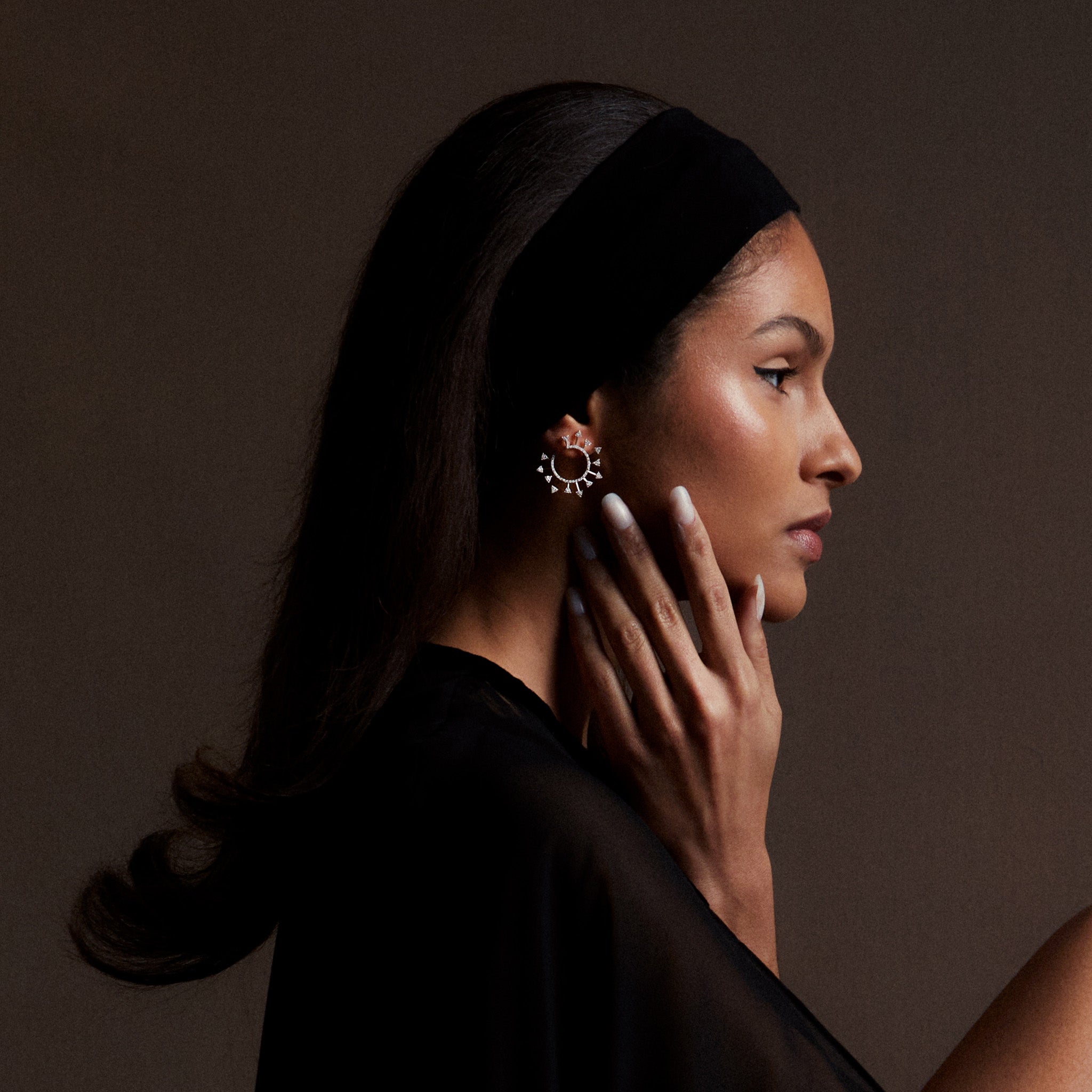 White gold diamond spiral earrings on a model.