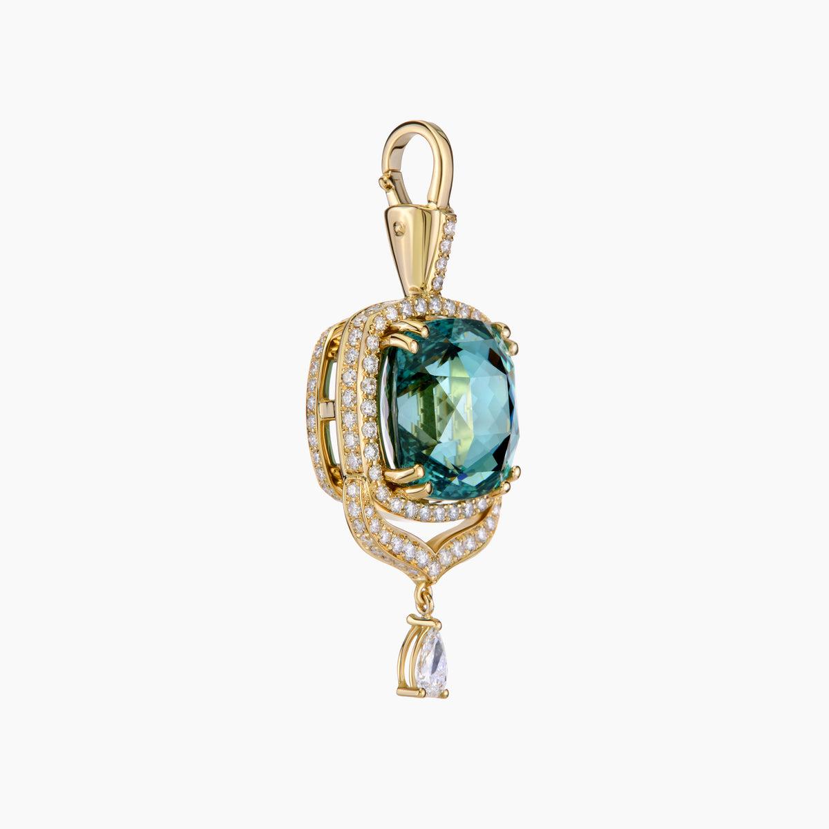 Gold pendant with a tourmaline gemstone on a white background
